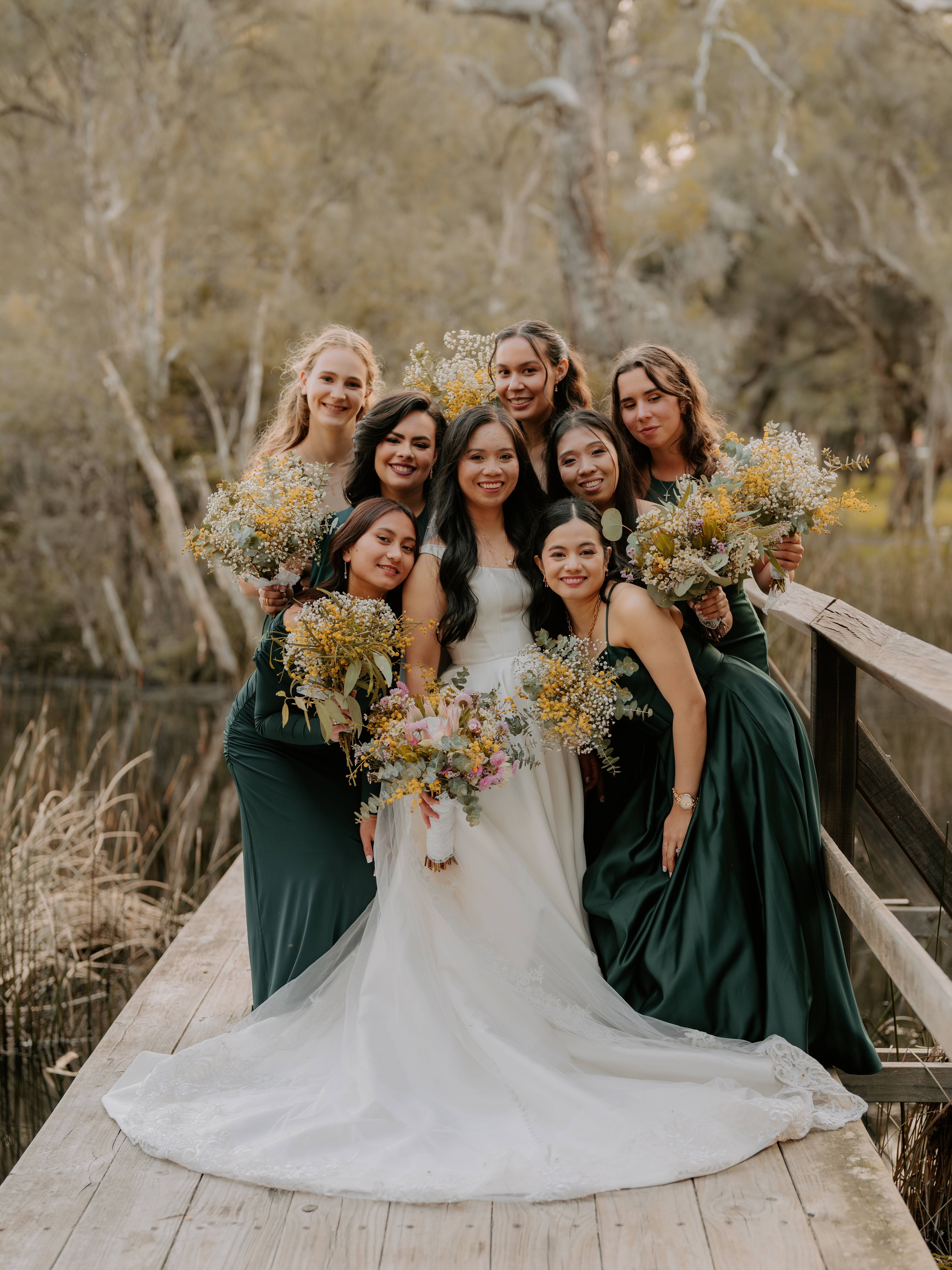 A group of people holding flowers after a wedding