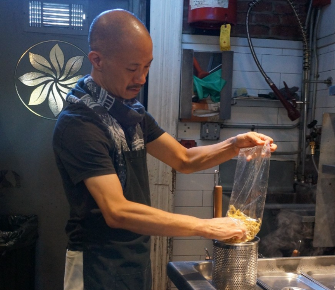 picture of Steven Tseng preparing a dish at his restaurant pinwheel garden