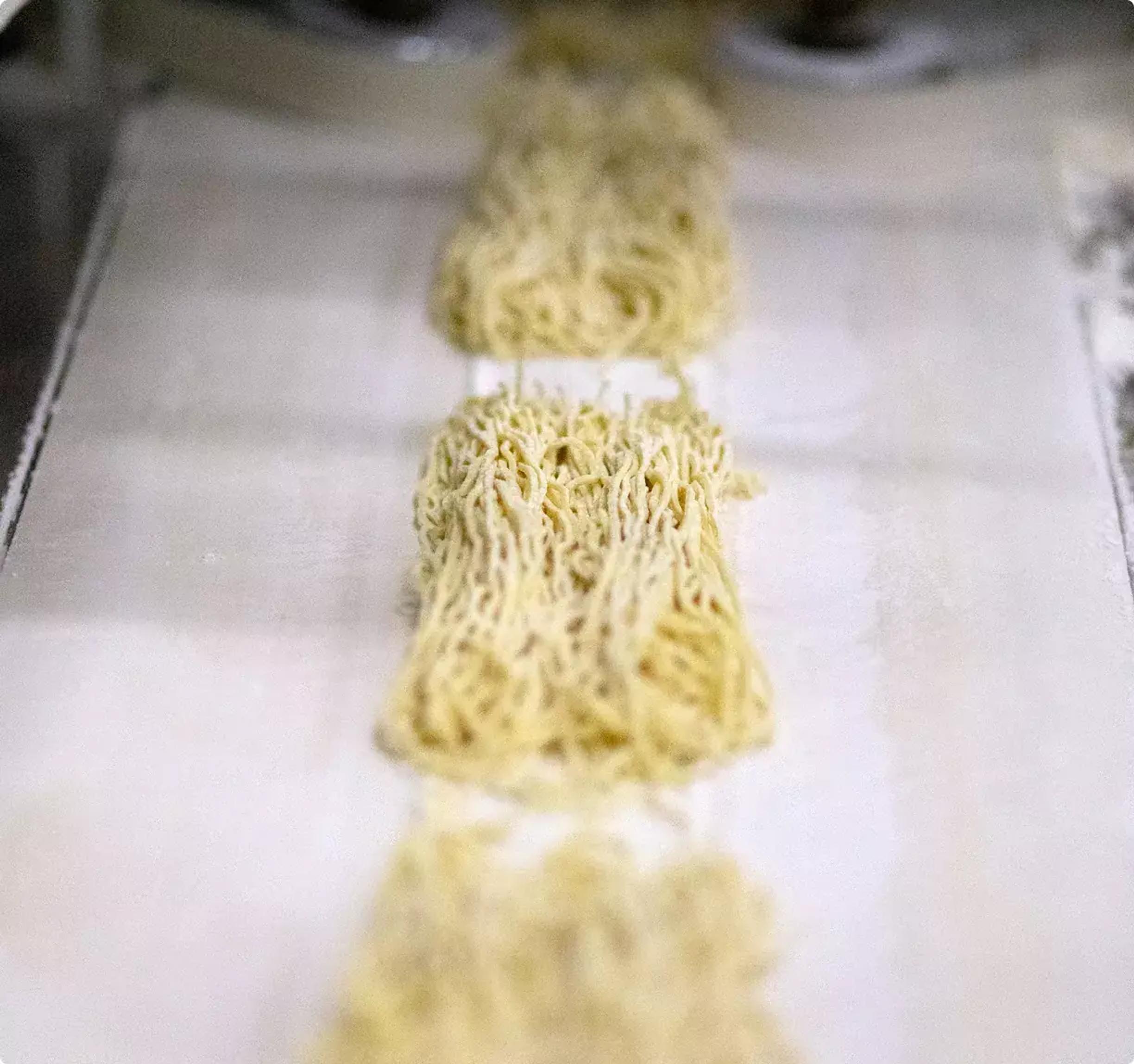 A bowl of ramen next to individual bowls of toppings