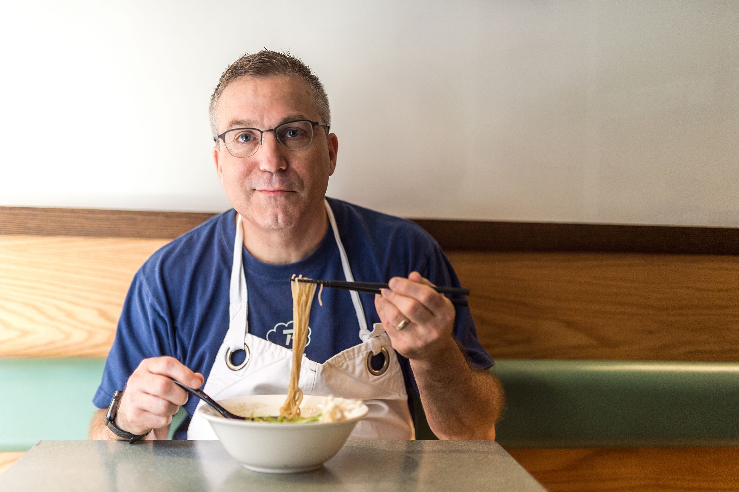 Ivan Orkin eating a bowl of ramen at his restaurant, Ivan Ramen