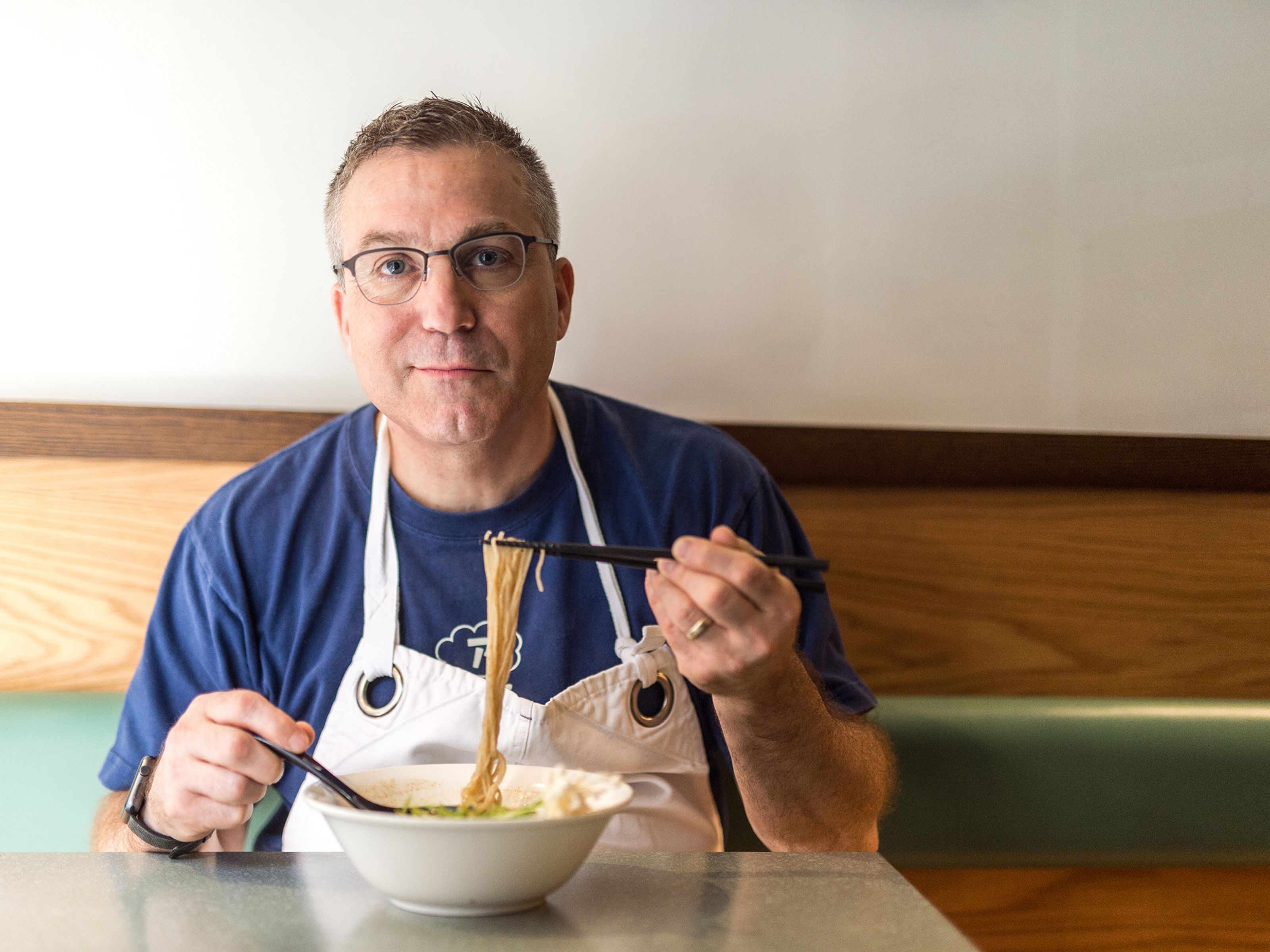 Ivan Orkin eating a bowl of ramen at his restaurant, Ivan Ramen