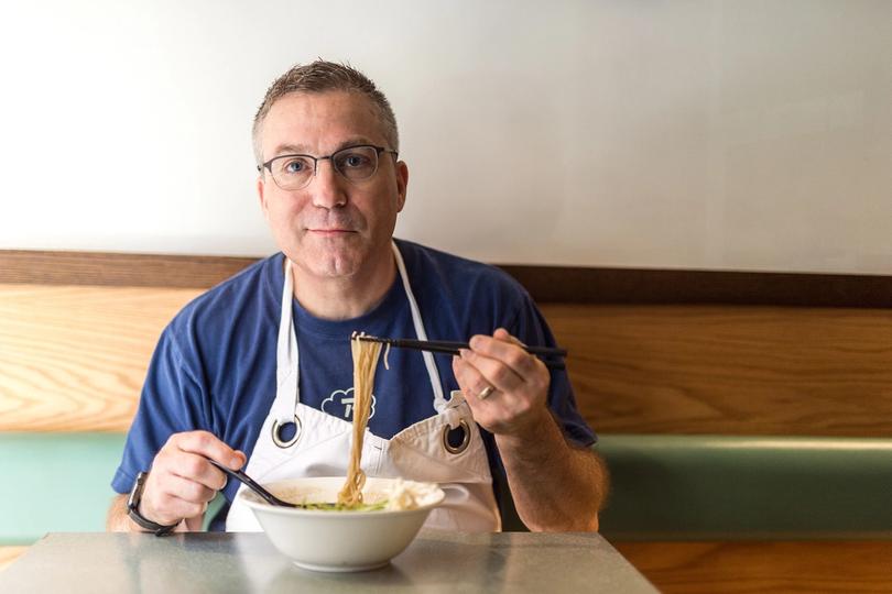 Ivan Orkin eating a bowl of ramen at his restaurant, Ivan Ramen