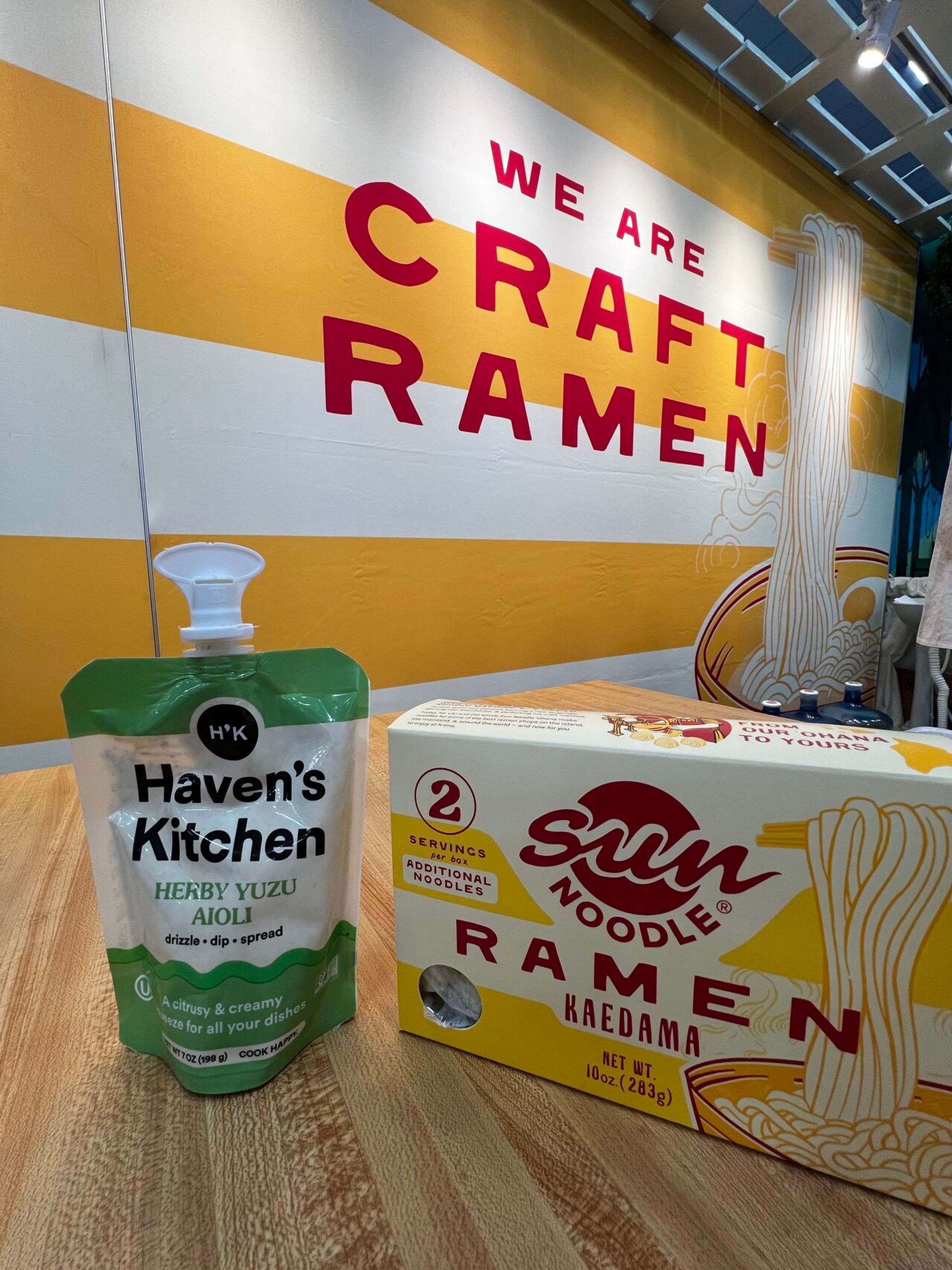 A box of Kaedama ramen kit with new packaging next to Haven's Kitchen yuzu aioli.