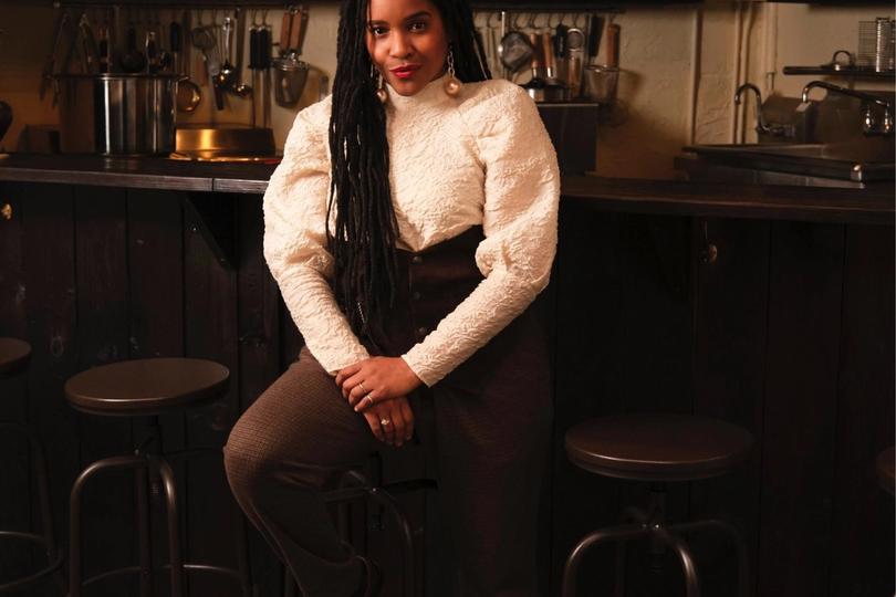 Rasheeda sitting on a stool at Ramen by Ra