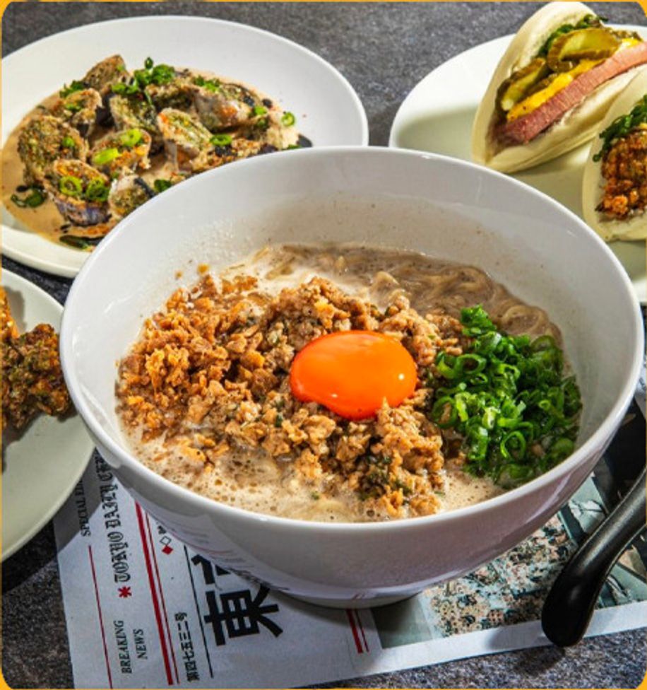 Mazemen bowl topped with ground pork and an egg yolk
