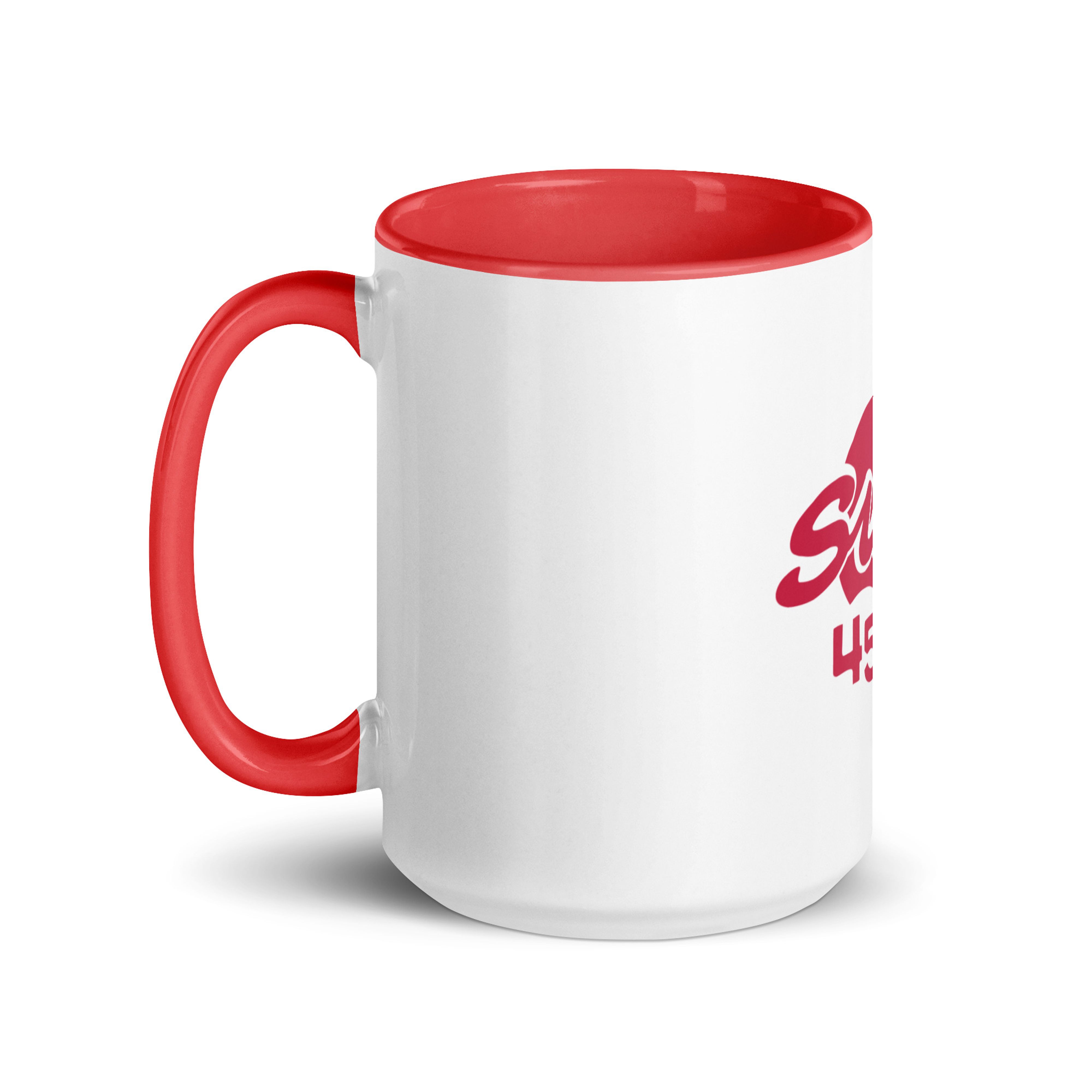 White ceramic mug with red interior and red handle, shown from the left with the red "Sun" anniversary logo partially visible on the side.