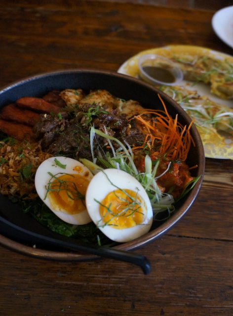 Finished dish plated with colorful toppings