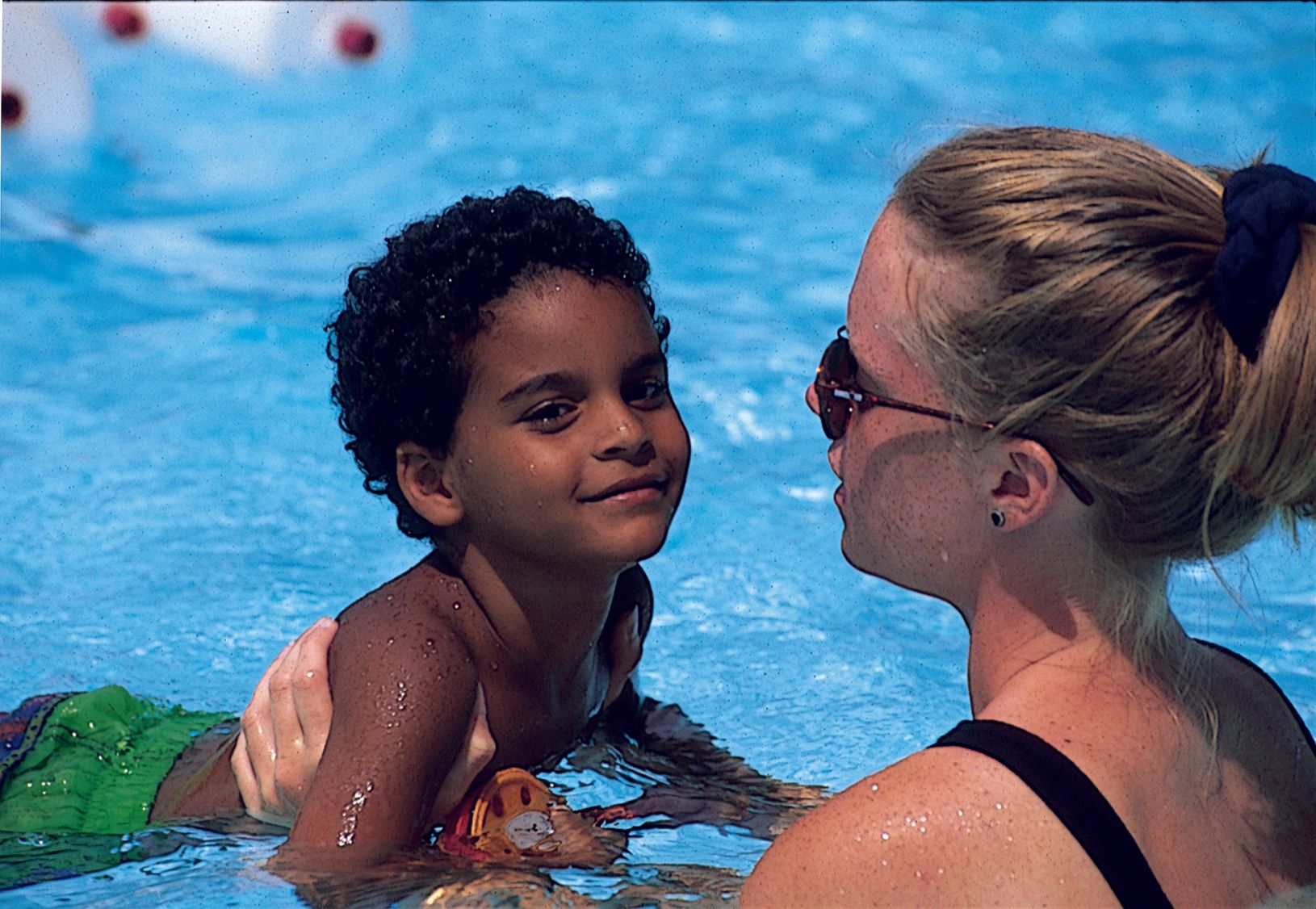 camper with swim instructor in the pool at Rambling Pines Day Camp