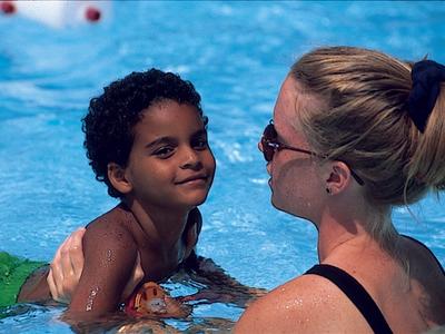 camper with swim instructor in the pool at Rambling Pines Day Camp