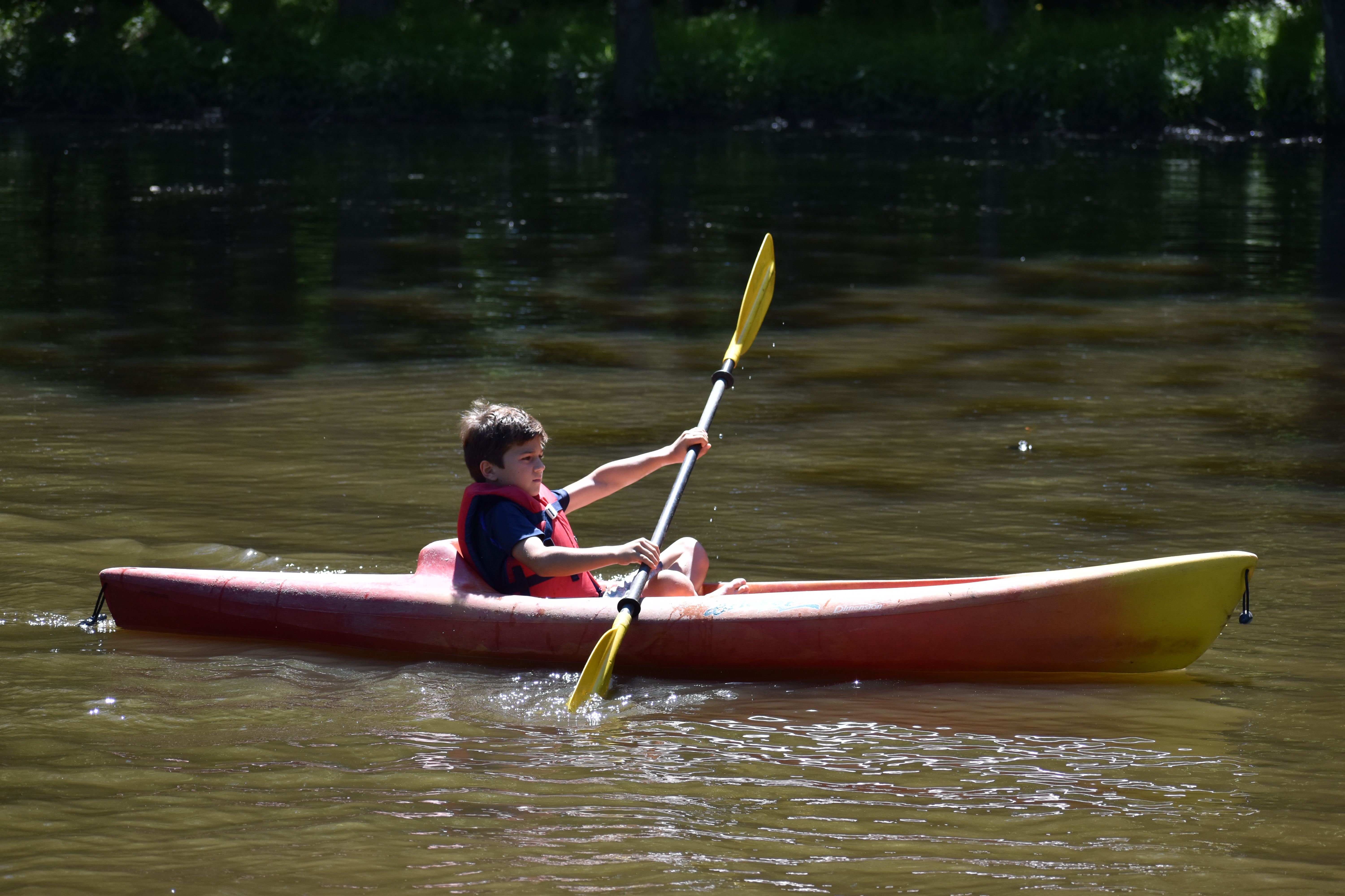 camper canoeing on the lake at Rambling Pines Day Camp