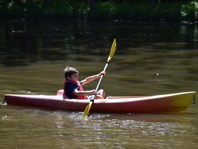 camper canoeing on the lake at Rambling Pines Day Camp