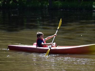 camper canoeing on the lake at Rambling Pines Day Camp