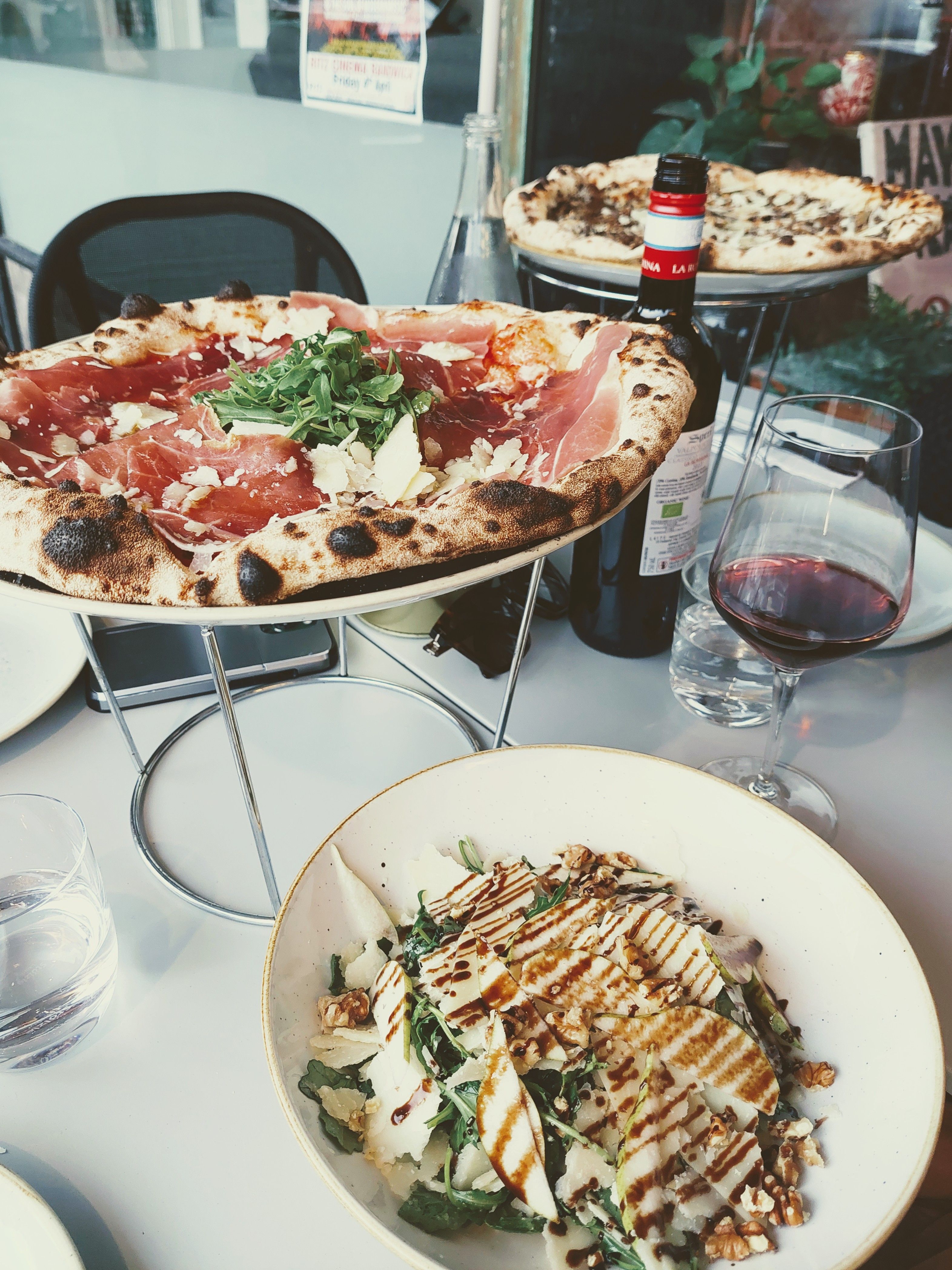 Woodfired pizza, salad and a glass of wine
