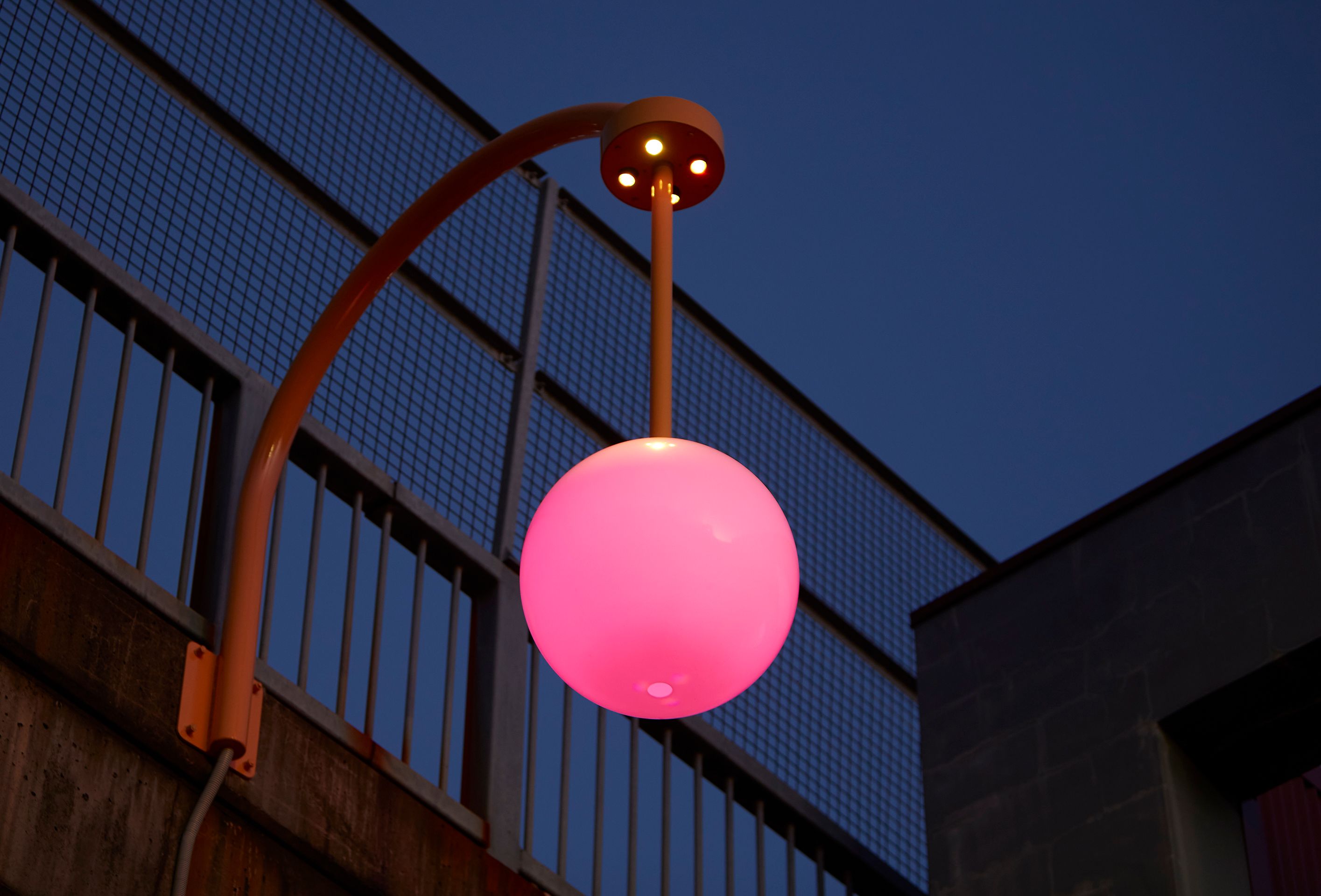 A glowing pink light in Rochelle Haley's outdoor artwork Lunar Sway.