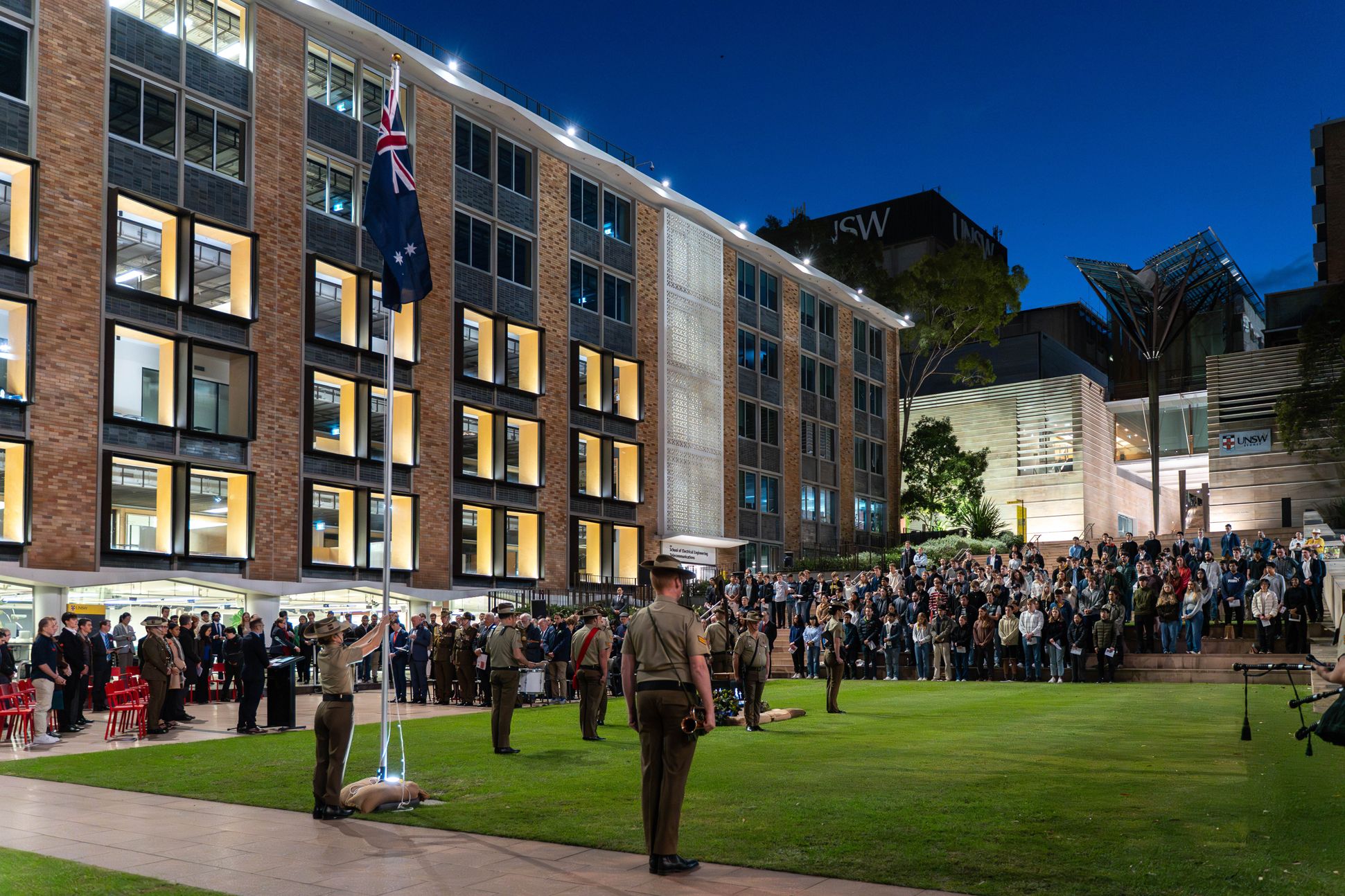 ANZAC Day dawn service in progress in a grassy quadrangle on the UNSW campus.