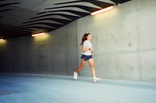 A woman running in Salomon running sneakers