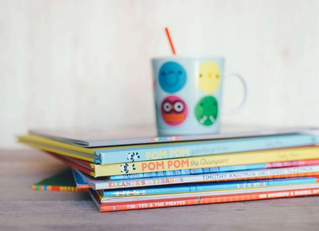 Canva Cup Placed On Top Of Stack Of Childrens Books