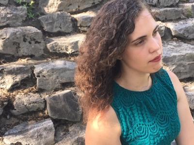 A photo of Cara Dees looking away from the camera. 