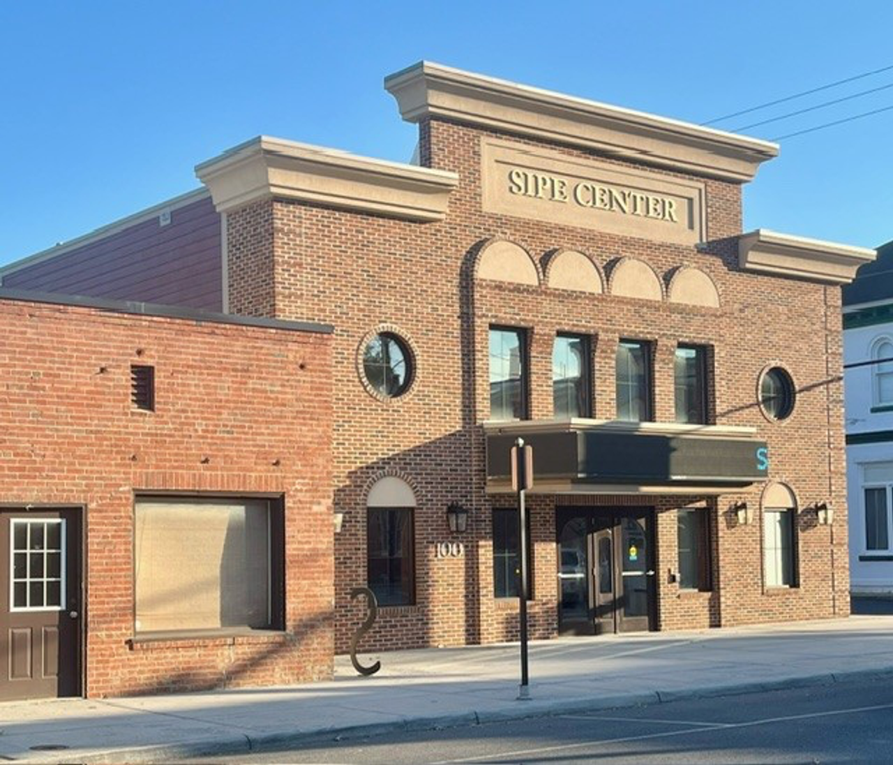 front of a two story brick building with Sipe Center at the top