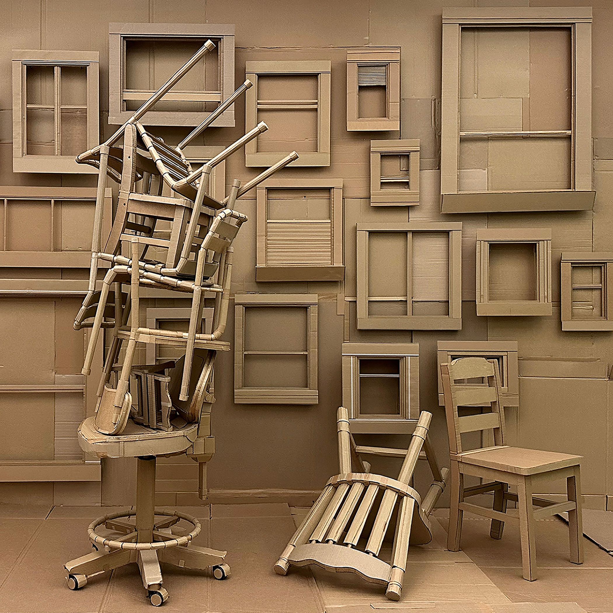 Photograph of art installation that features a room full of windows and chairs all made out of cardboard. 