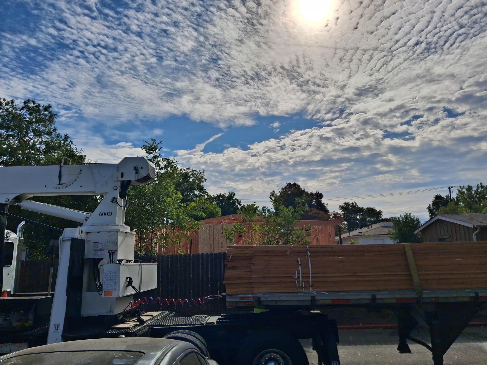 Crane set up to lift over the fence
