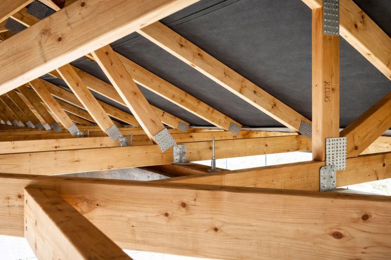 Close-up of engineered remodel roof trusses with galvanized steel gusset plates and hurricane tie connections installed on an existing home renovation by Mike Walker Lumber Co Inc
