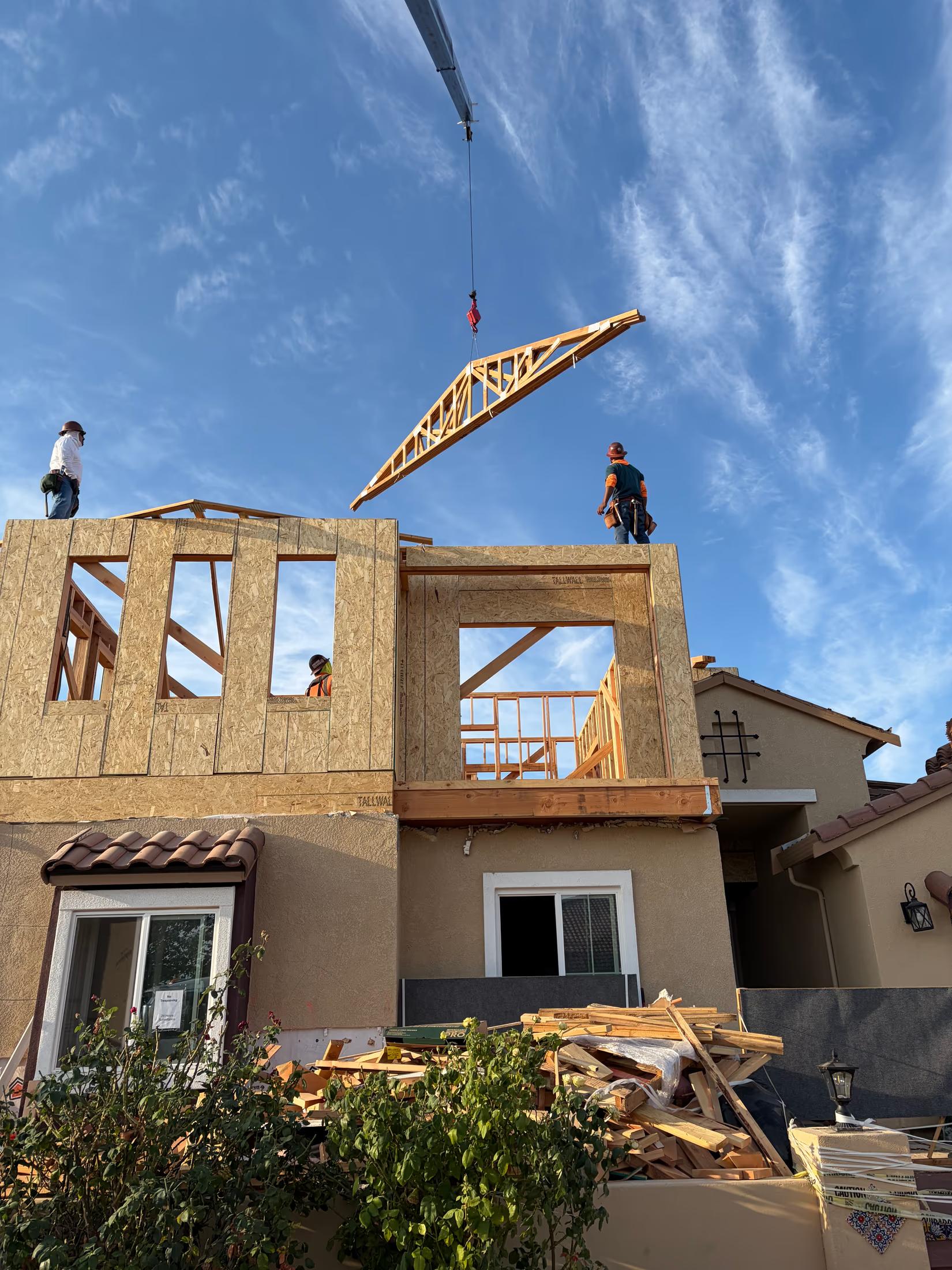 Crane setting trusses on the new second floor