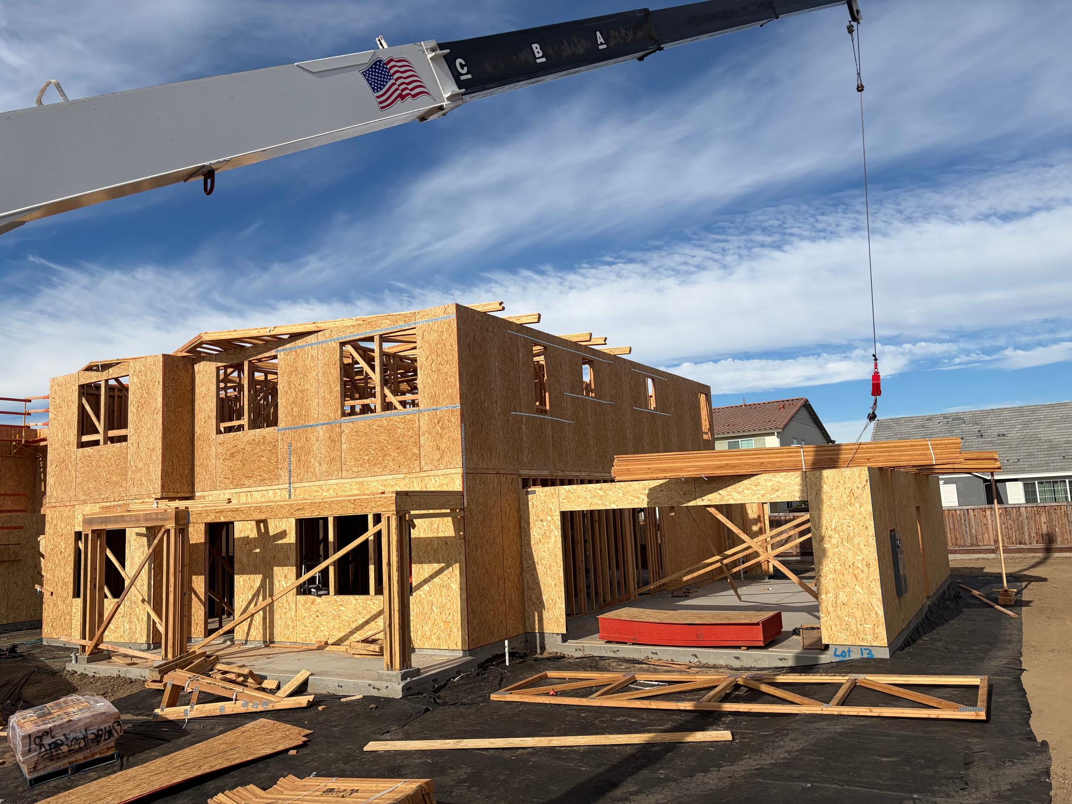 Crane setting the roof package on Lot 13