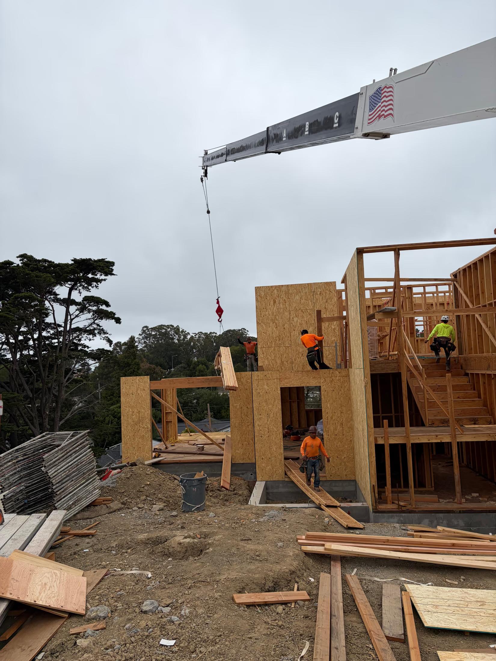 Crane setting the roof package