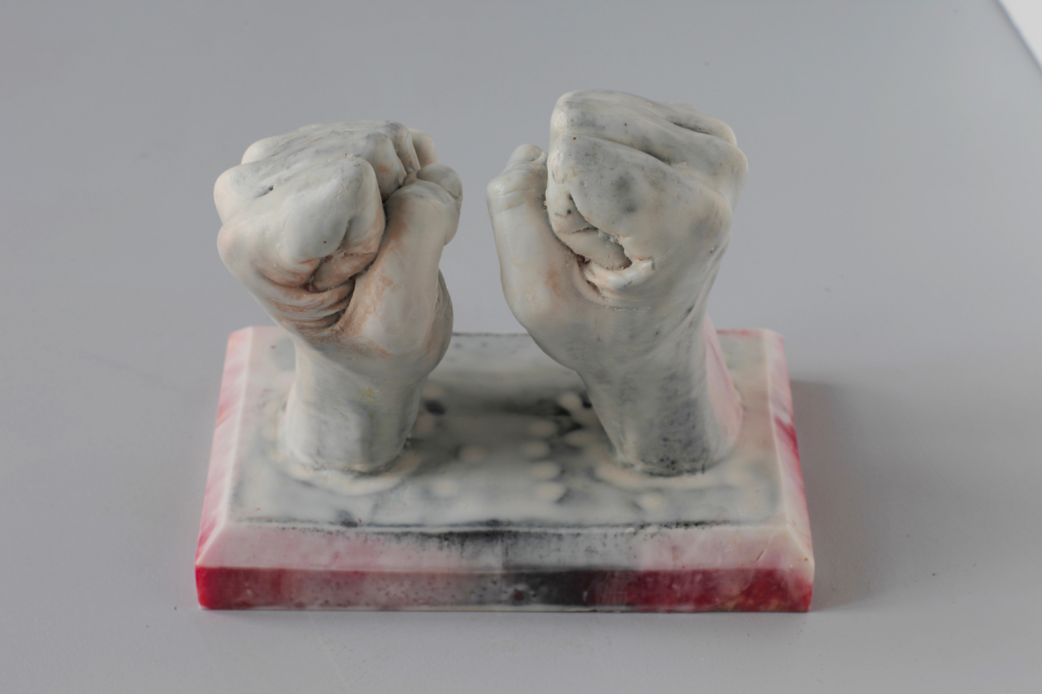 Sculpture of two fists in white