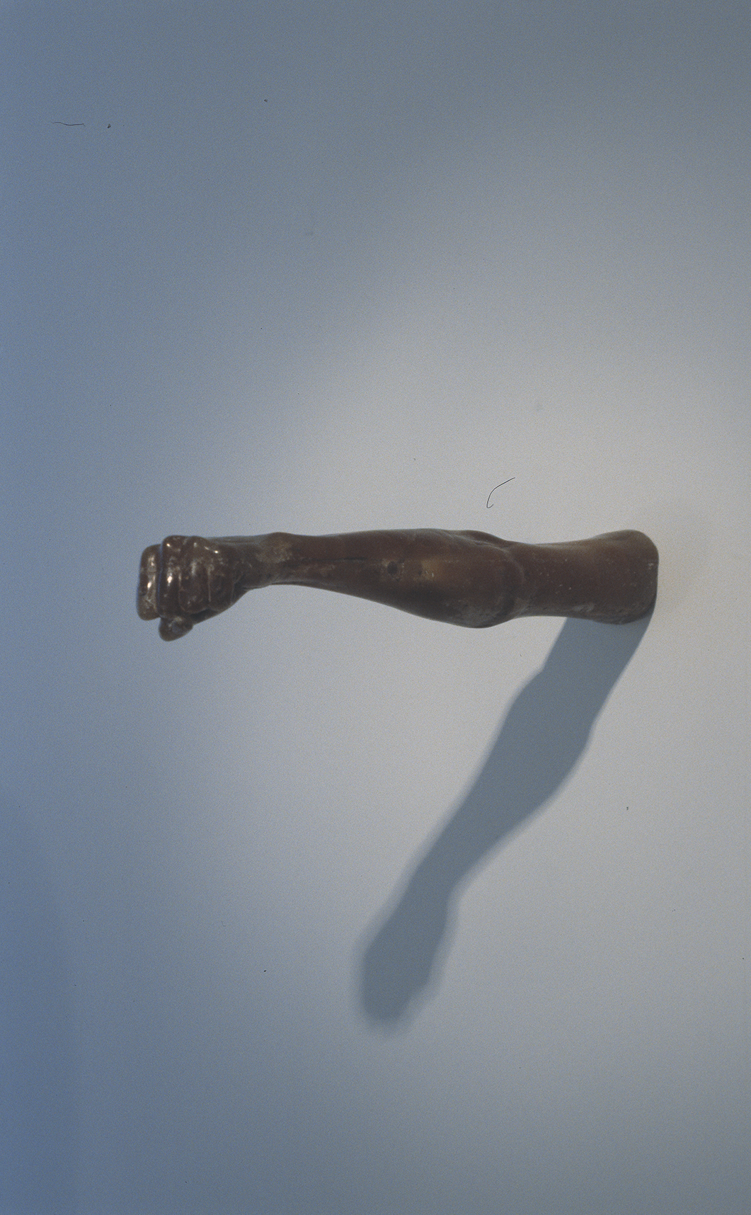 Sculpture of an arm sticking out of a wall