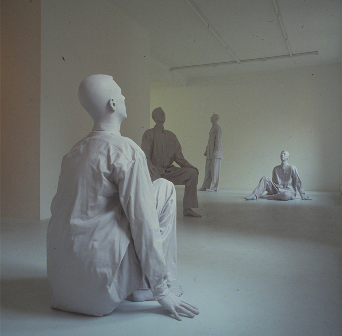 four white statues in different positions