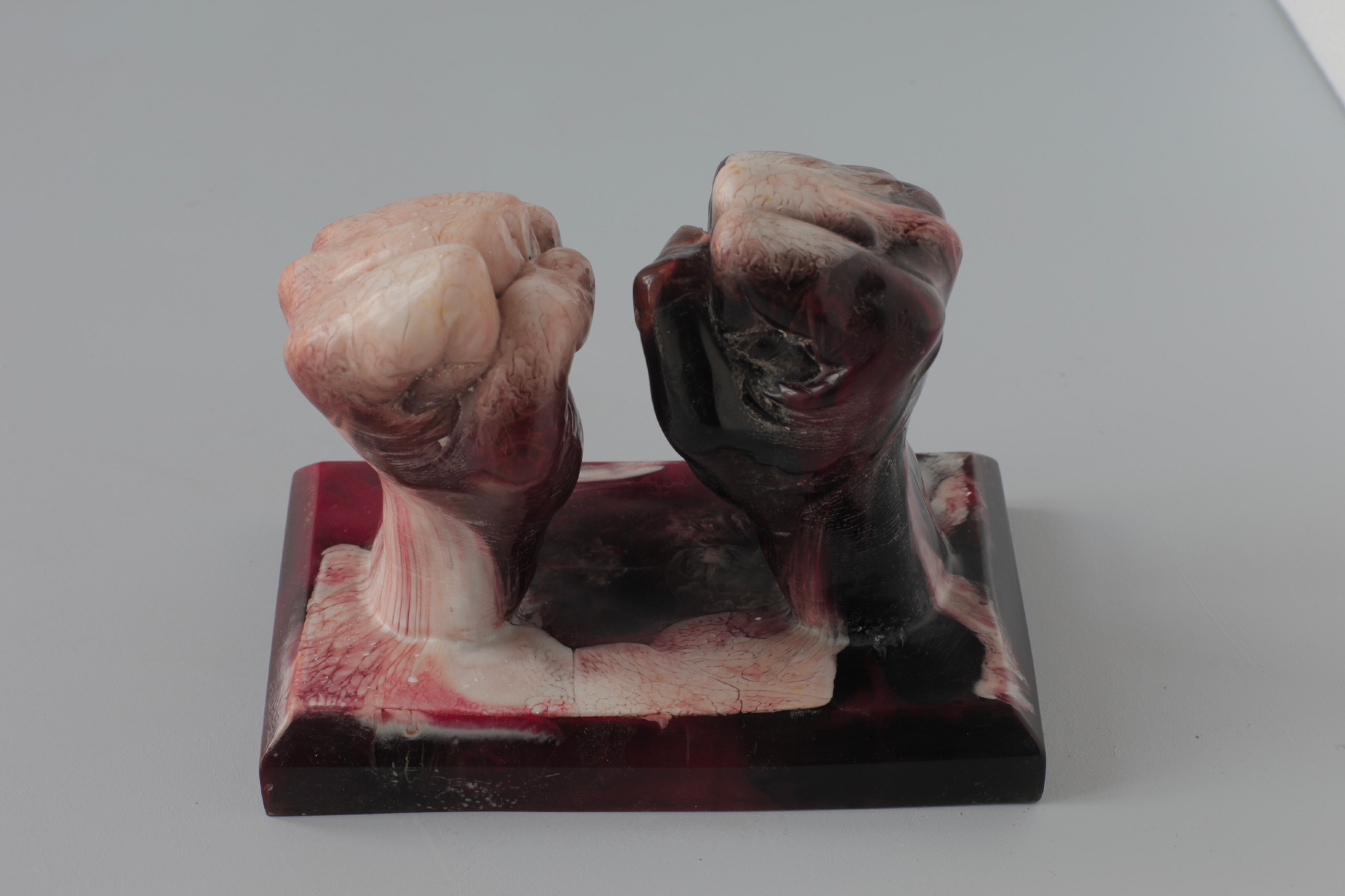 Sculpture of two fists in red