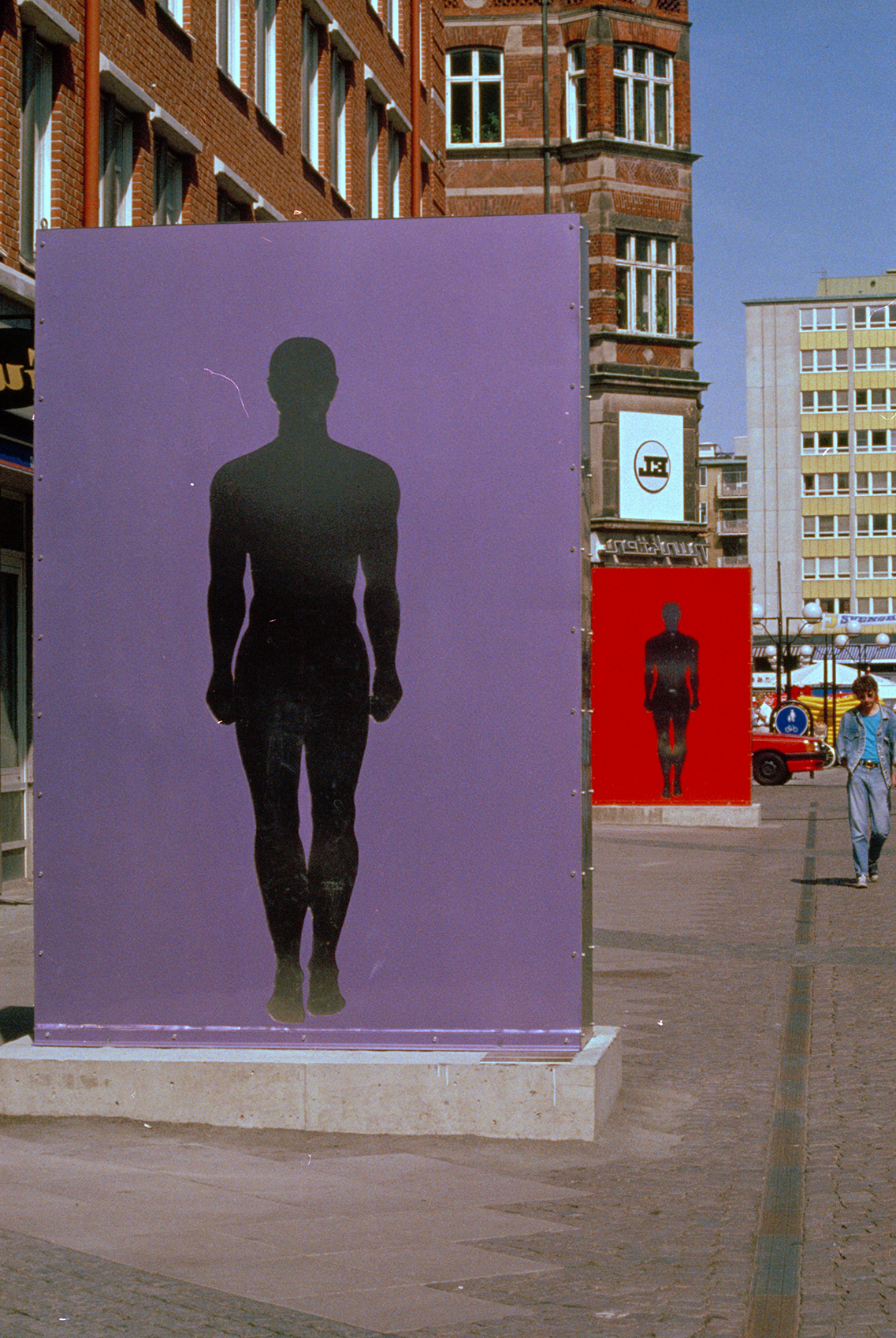 Two large artworks of a silhouette of a man in a city