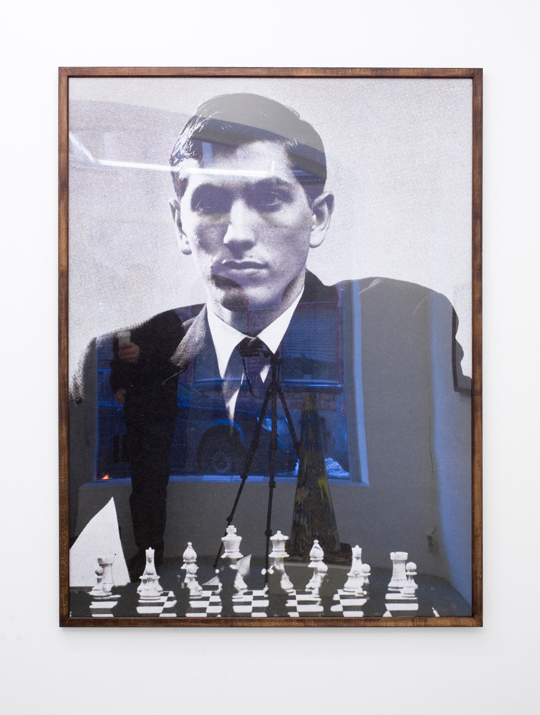 Framed photograph of a man in front of a chess board