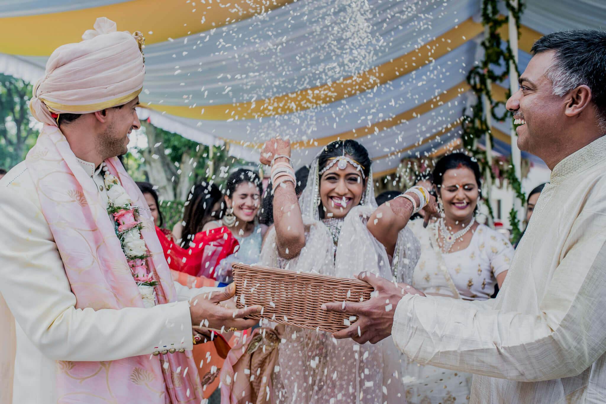 Anu and Raghu exchanged rice shower during wedding ceremony in Nepal, surrounded by smiling family