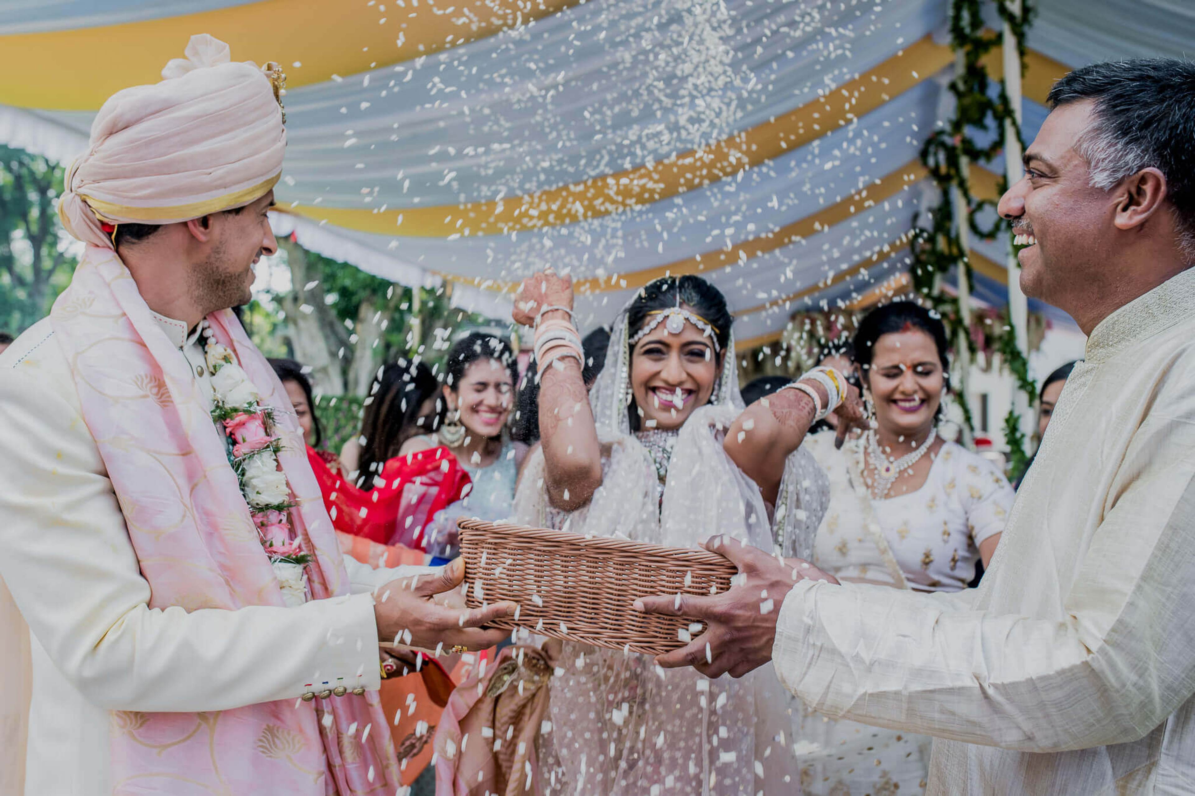 Anu and Raghu exchanged rice shower during wedding ceremony in Nepal, surrounded by smiling family