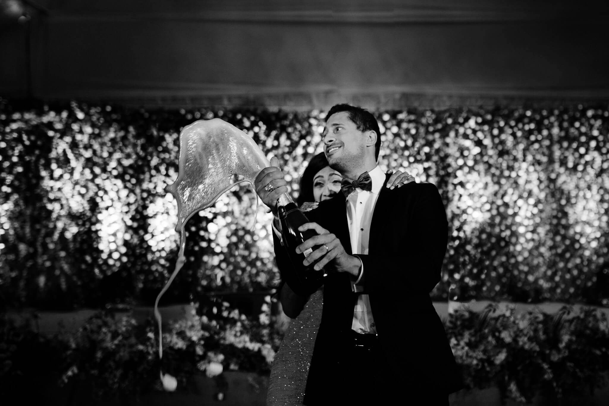 Anu and Raghu laugh together before a glittering sequin backdrop at their wedding reception in Nepal