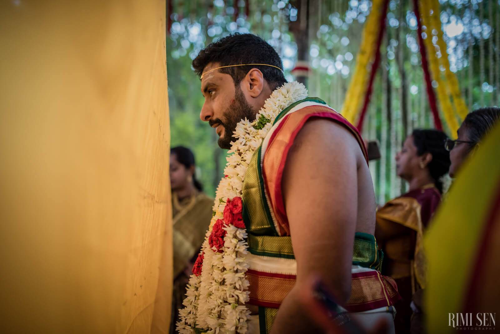 Sridhar in traditional attire with jasmine garland at wedding ceremony in Bangalore