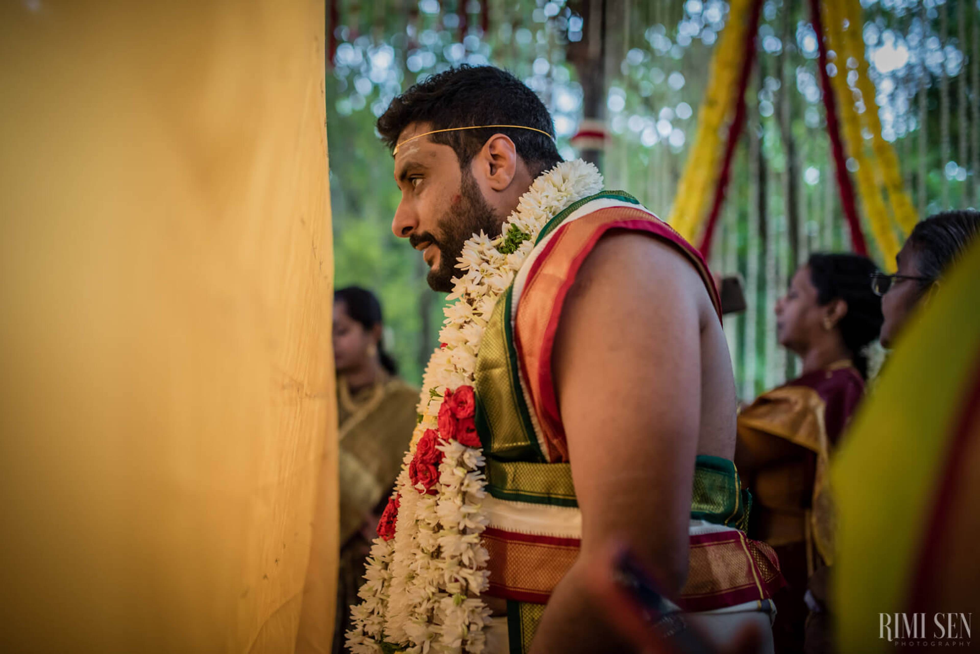 Sridhar in traditional attire with jasmine garland at wedding ceremony in Bangalore