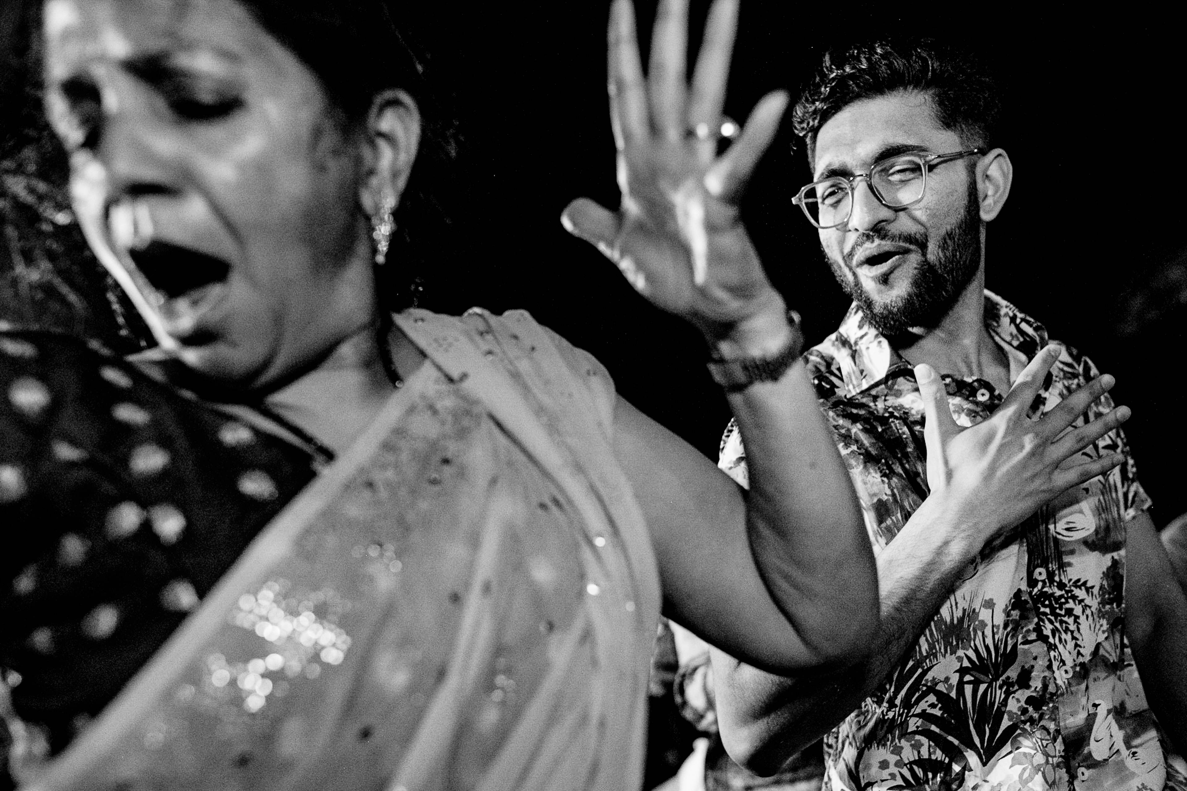Avani and Srikant dancing joyfully at night in Goa, black and white candid moment
