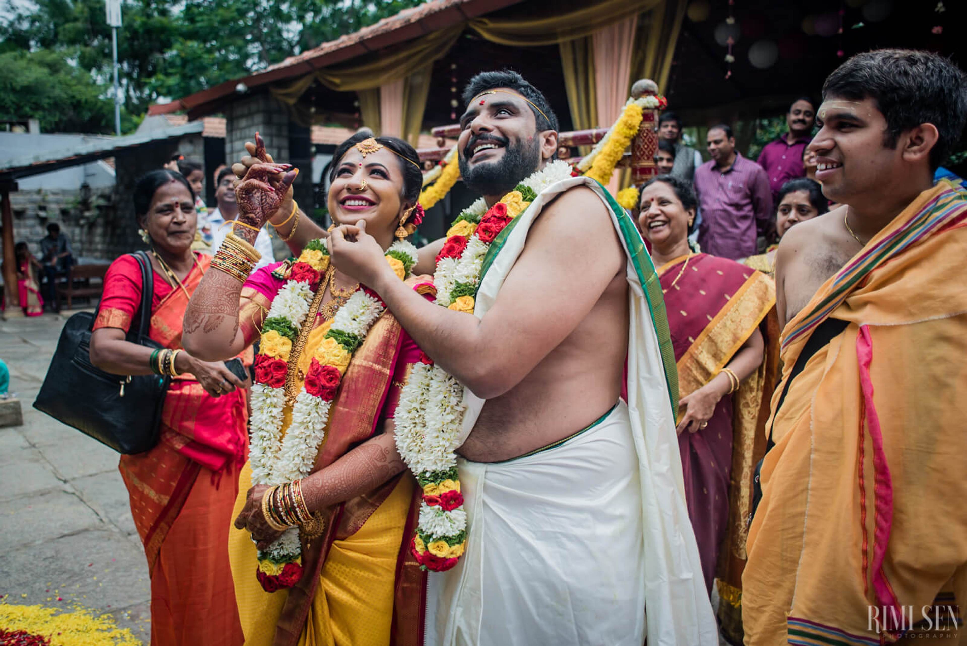 Nivetha & Sridhar celebrate with flower garlands and family in traditional attire at their Bangalore wedding