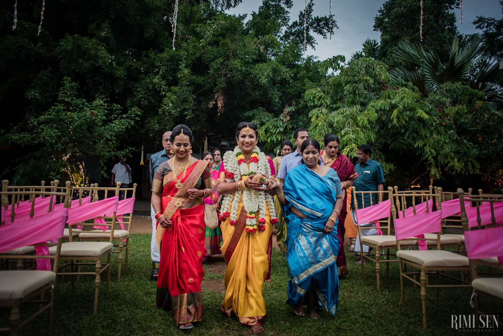 Nivetha and Sridhar's wedding ceremony in Bangalore with family in traditional attire and pink fabric decorations