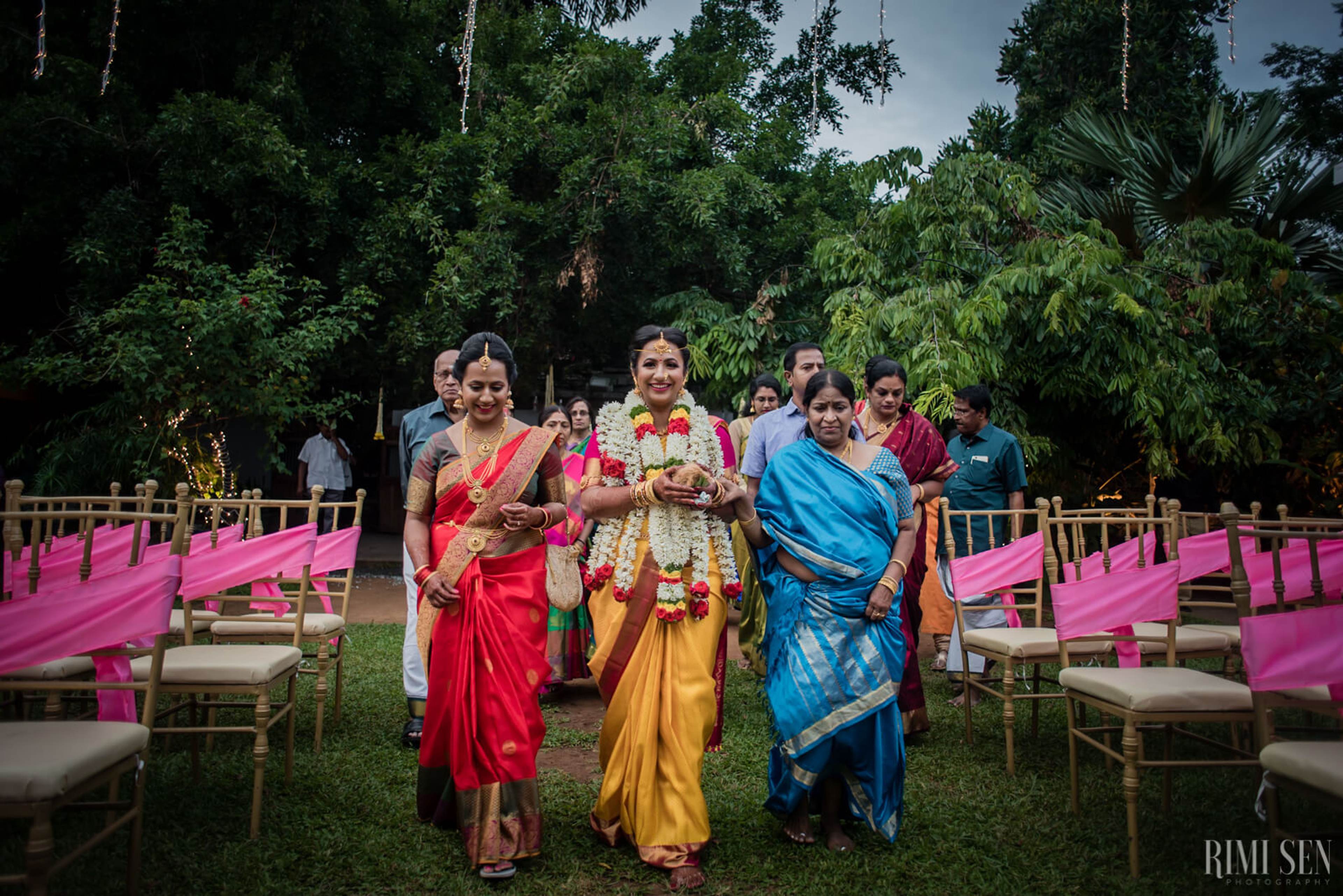 Nivetha and Sridhar's wedding ceremony in Bangalore with family in traditional attire and pink fabric decorations