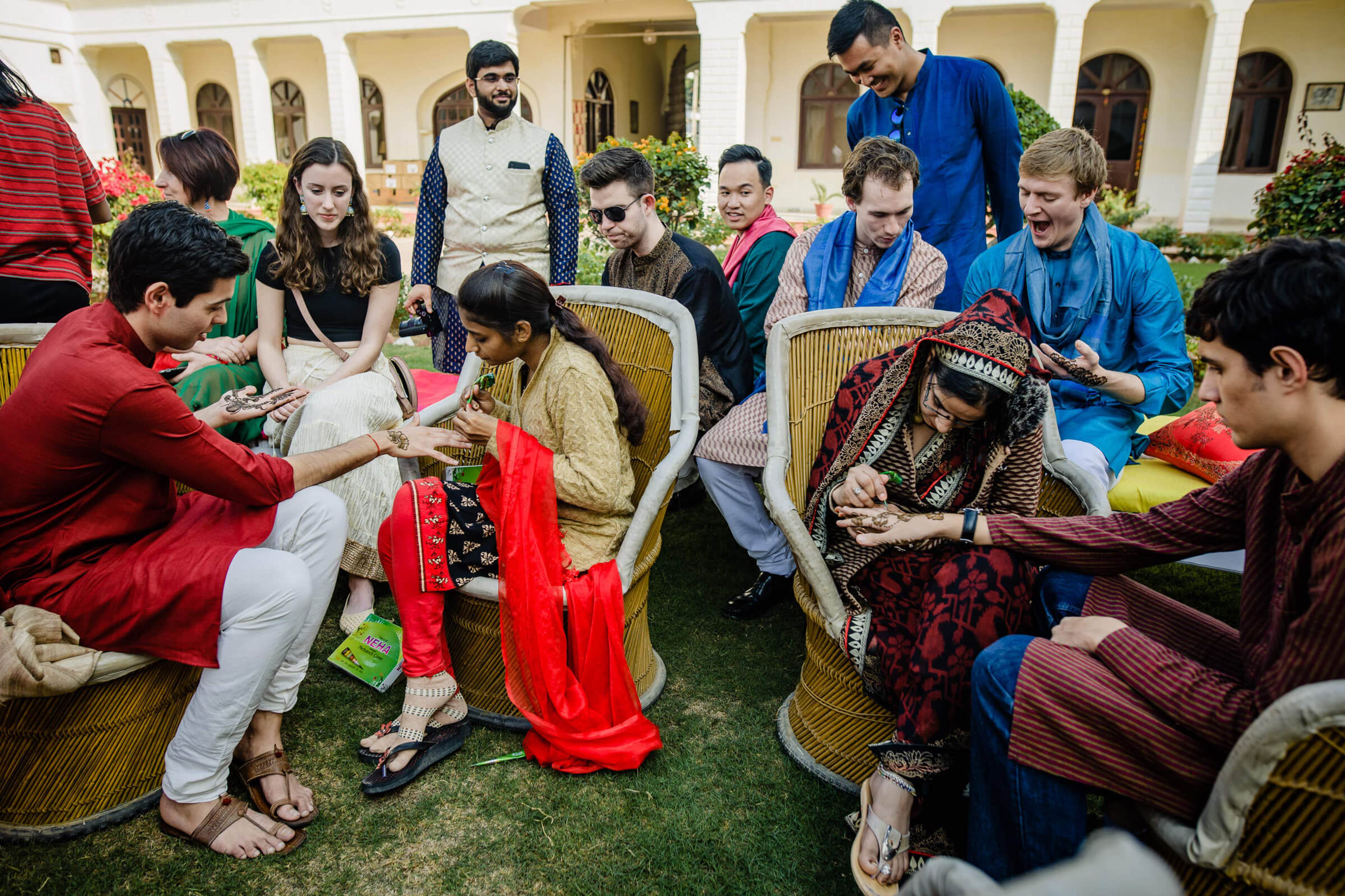Maitrayee and Eric's guests gathered in a Rajasthan courtyard, exchanging colorful fabrics and gifts