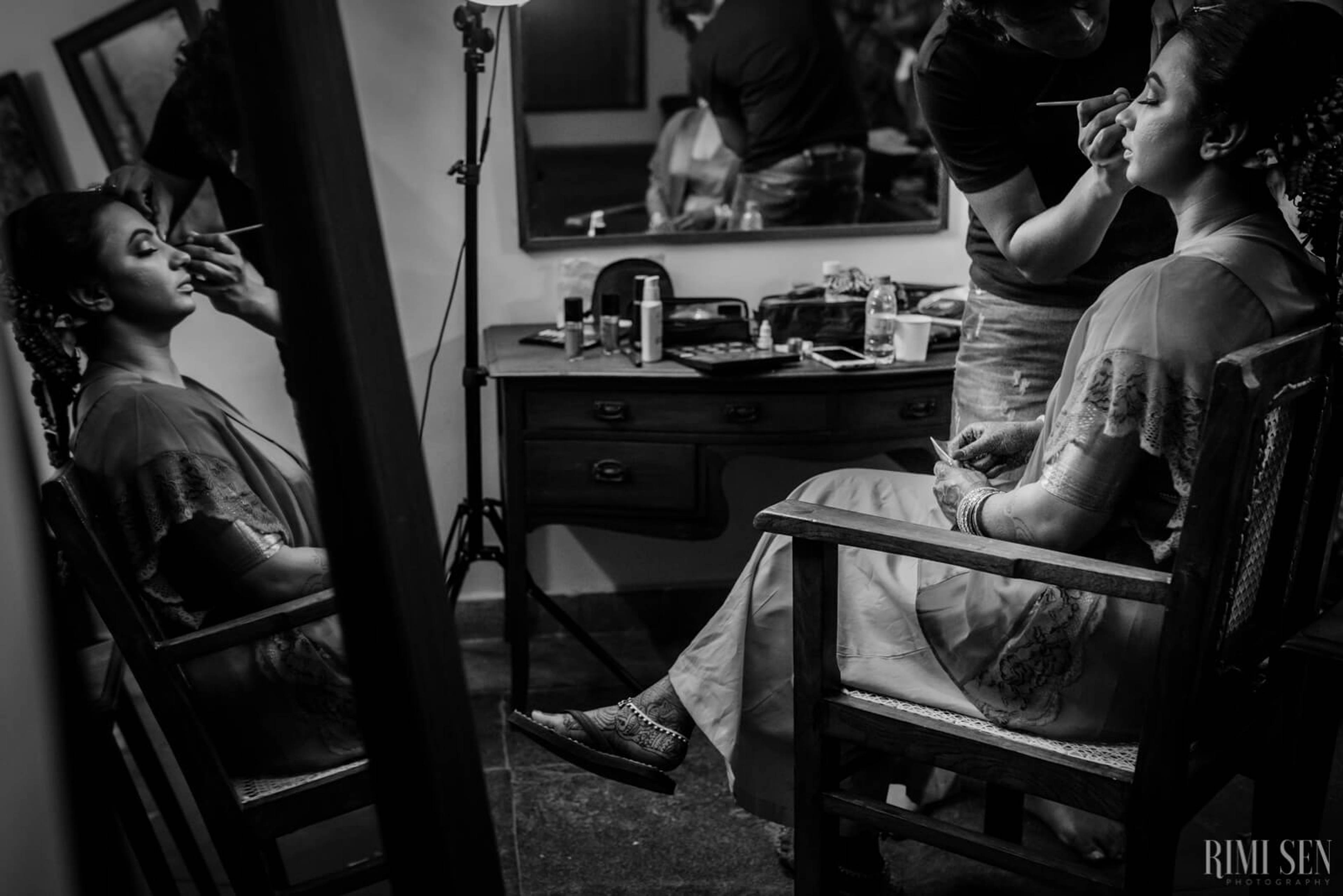 Nivetha getting ready with makeup artist in Bangalore bridal suite, black and white candid moment