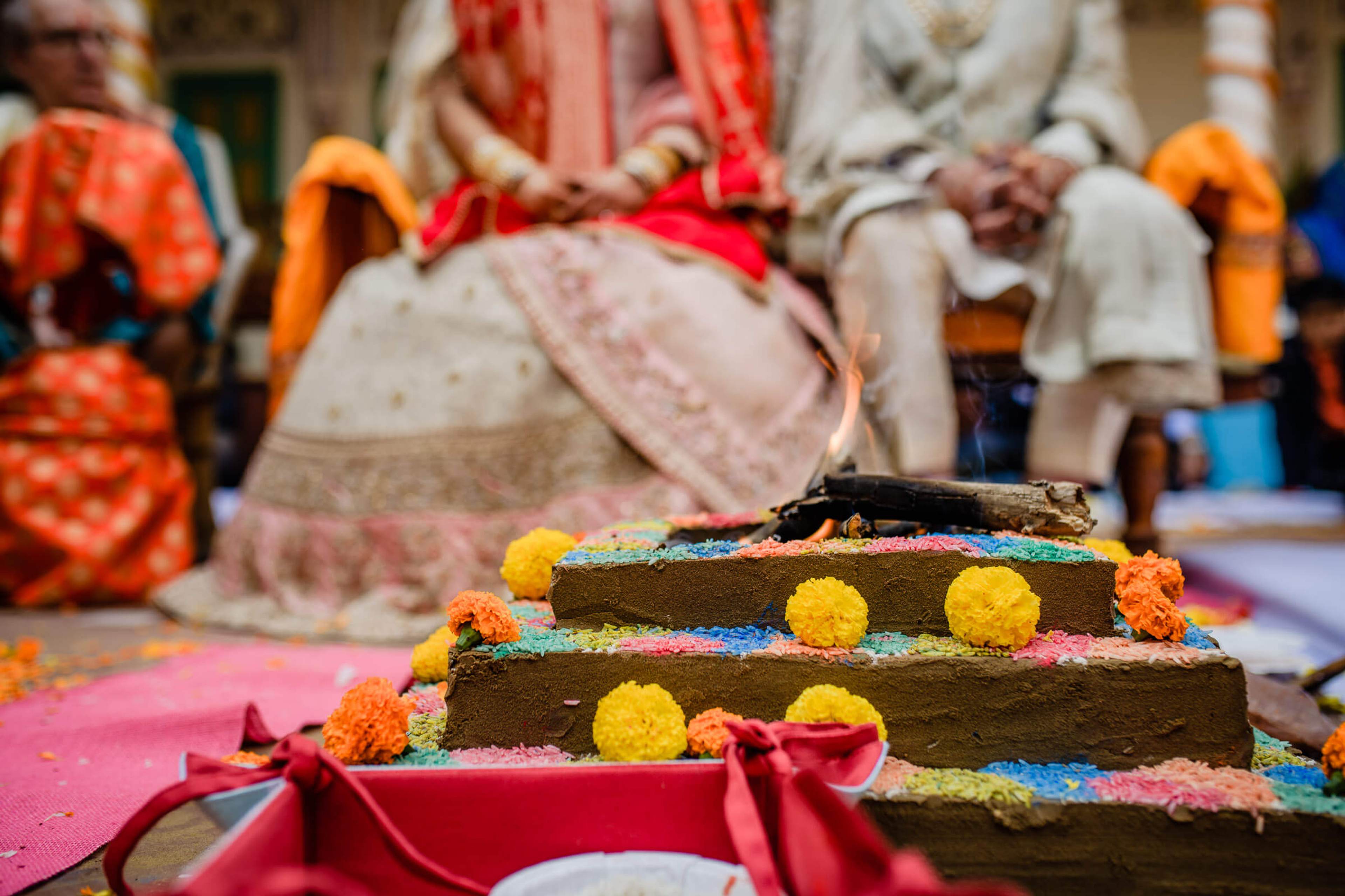 Decorated ceremonial platform with colorful flowers and powder in Rajasthan wedding celebration