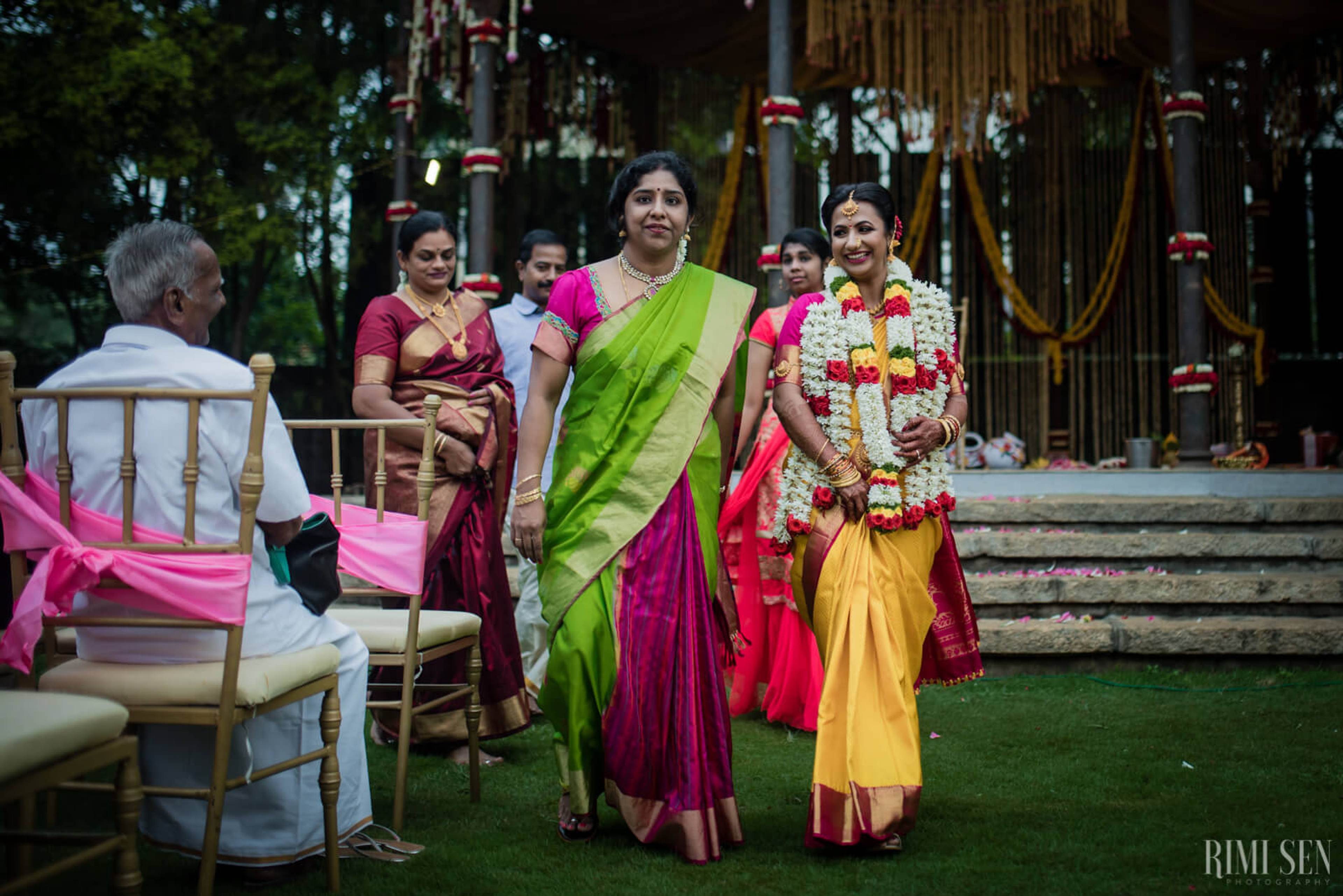 Nivetha and Sridhar's wedding ceremony in Bangalore with family in traditional attire and floral garland