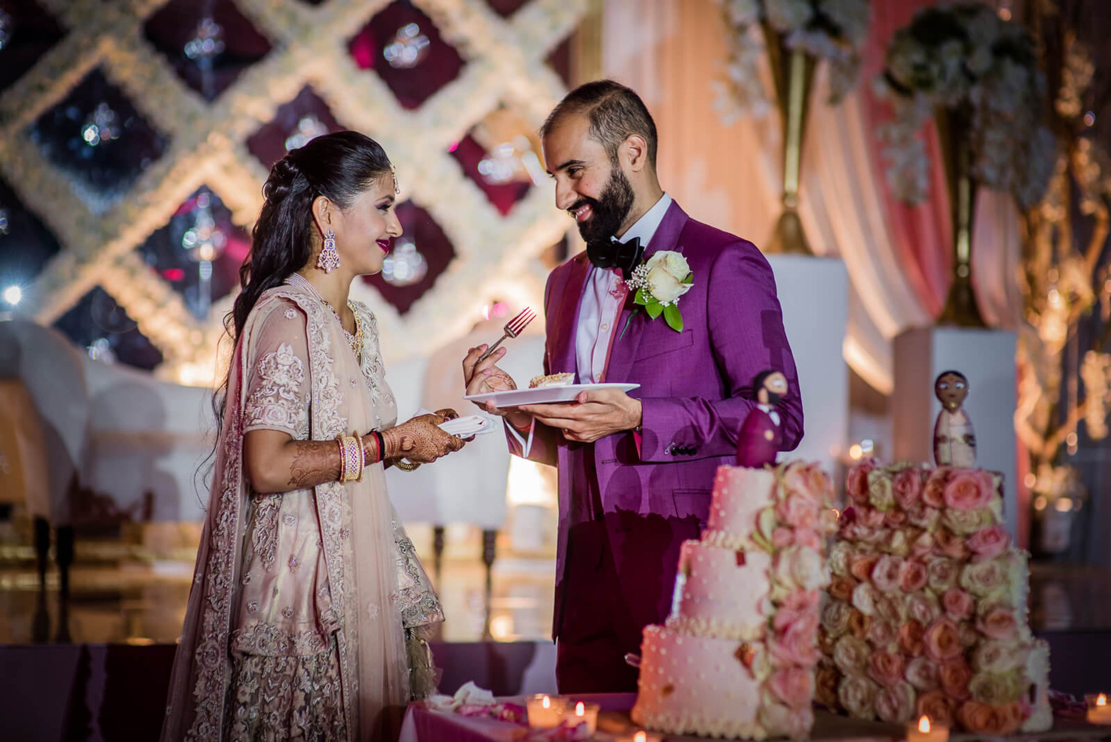 Barkha and Ankit exchange vows at ornate altar with purple backdrop and floral arrangements in New York