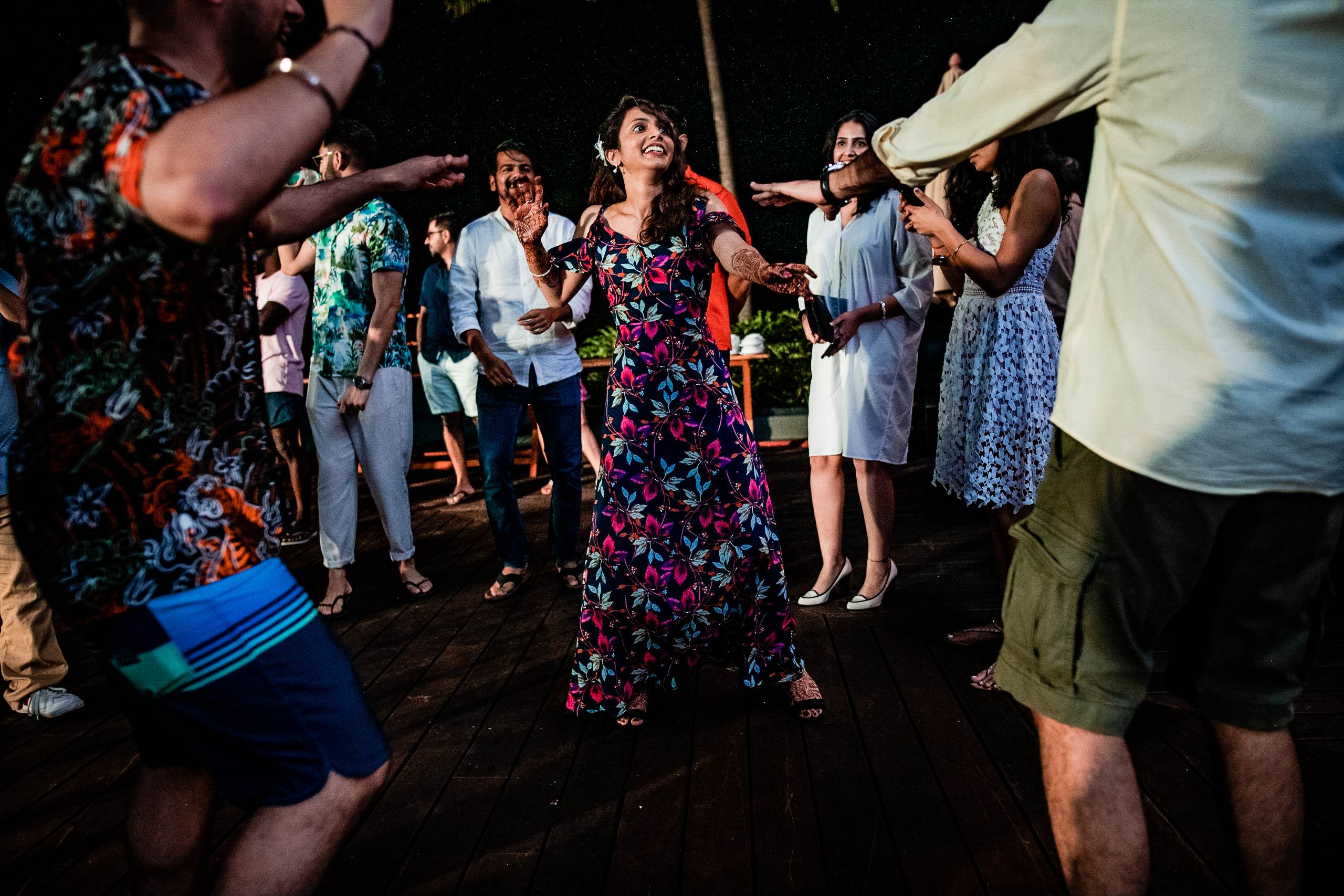 Avani dancing with guests under warm evening light at a Goa wedding celebration